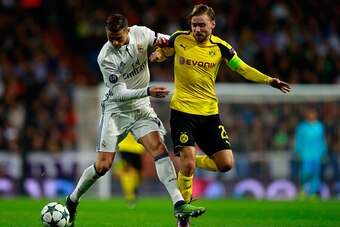 MADRID, SPAIN - DECEMBER 07:  Lucas Vazquez of Real Madrid (L) and Marcel Schmelzer of Borussia Dortmund (R) battle for possession during the UEFA Champions League Group F match between Real Madrid CF and Borussia Dortmund at the Bernabeu on December 7, 2