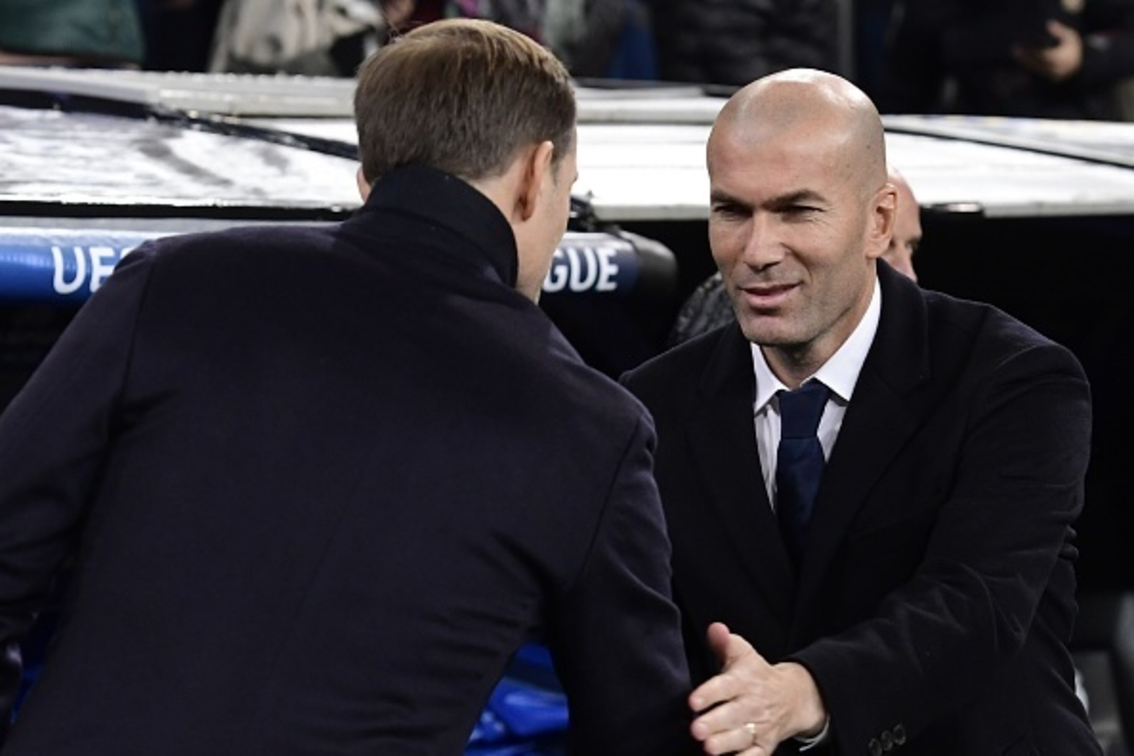Real Madrid's French coach Zinedine Zidane (R) shakes hands with Dortmund's coach Thomas Tuchel before during the UEFA Champions League football match Real Madrid CF vs Borussia Dortmund at the Santiago Bernabeu stadium in Madrid on December 7, 2016. / AF Real Madrid's French coach Zinedine Zidane (R) shakes hands with Dortmund's coach Thomas Tuchel before during the UEFA Champions League football match Real Madrid CF vs Borussia Dortmund at the Santiago Bernabeu stadium in Madrid on December 7, 2016. / AF