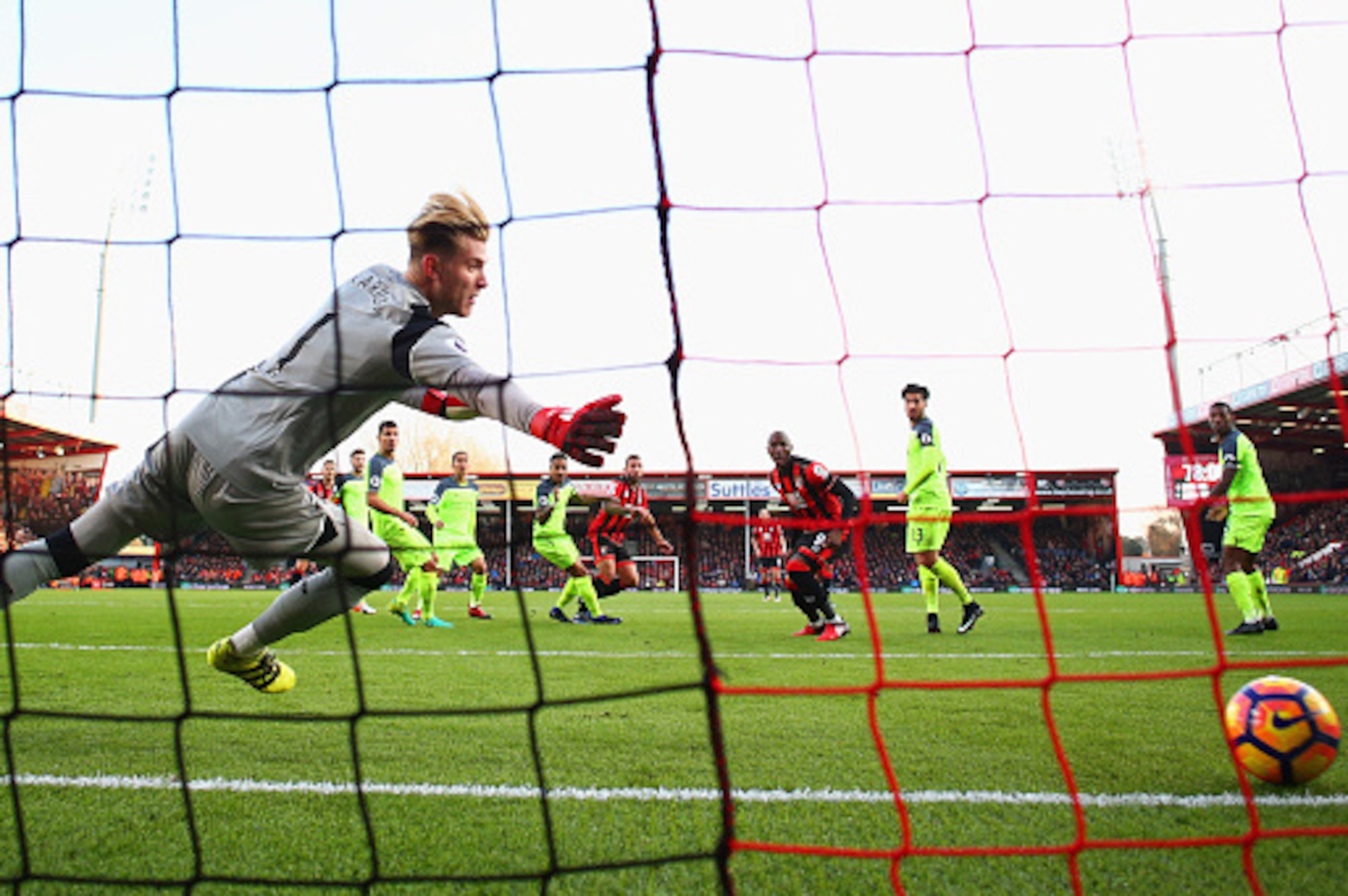 BOURNEMOUTH, ENGLAND - DECEMBER 04:  Loris Karius of Liverpool dives in vaine as as Steve Cook of AFC Bournemouth (C) scores their third goal during the Premier League match between AFC Bournemouth and Liverpool at Vitality Stadium on December 4, 2016 in 