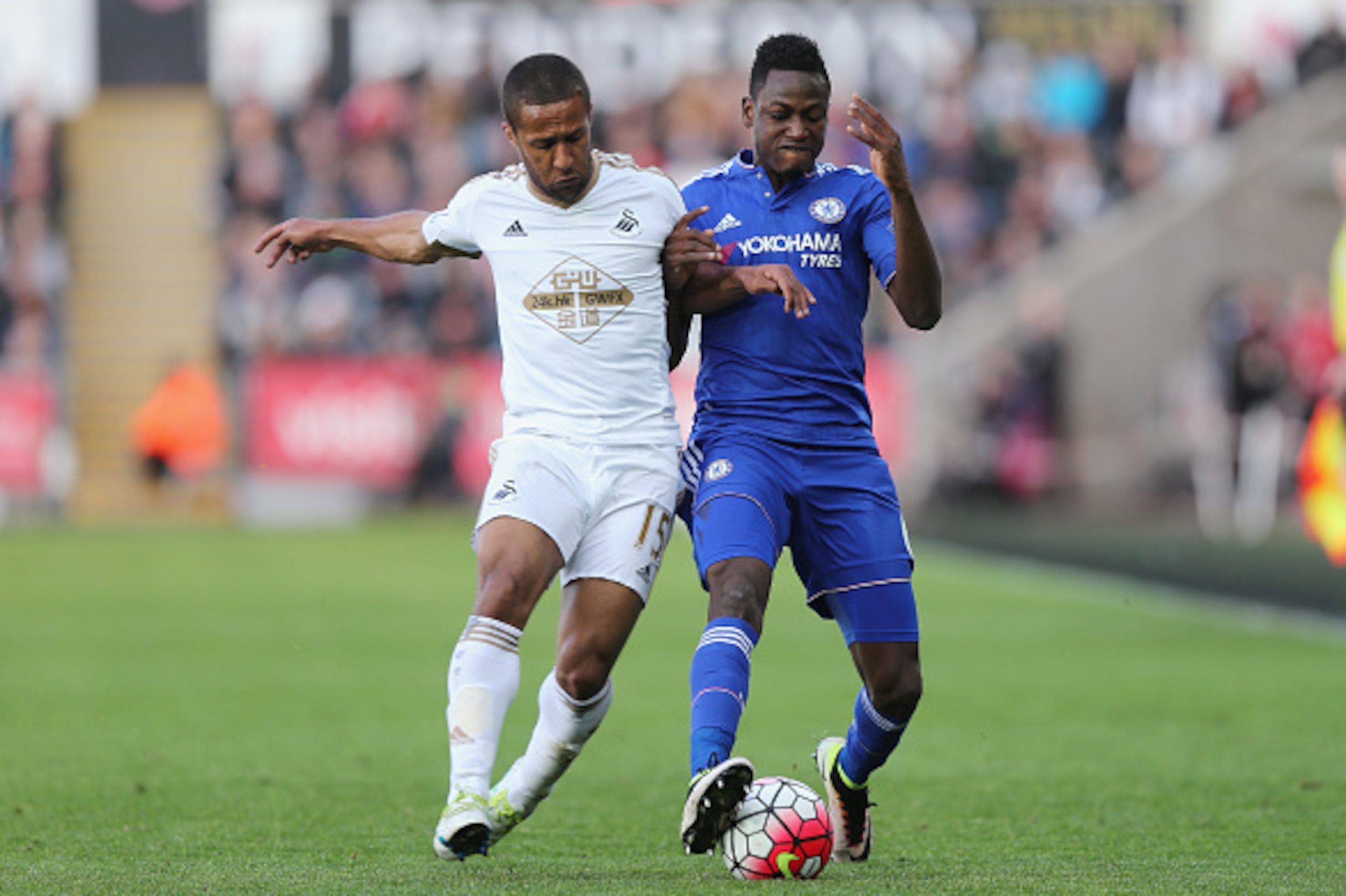 SWANSEA, WALES - APRIL 09: Baba Rahman of Chelsea holds off Wayne Routledge of Swansea during the Barclays Premier League match between Swansea City and Chelsea at the Liberty Stadium on April 9, 2016 in Swansea, Wales  (Photo by Alex Morton/Getty Images)