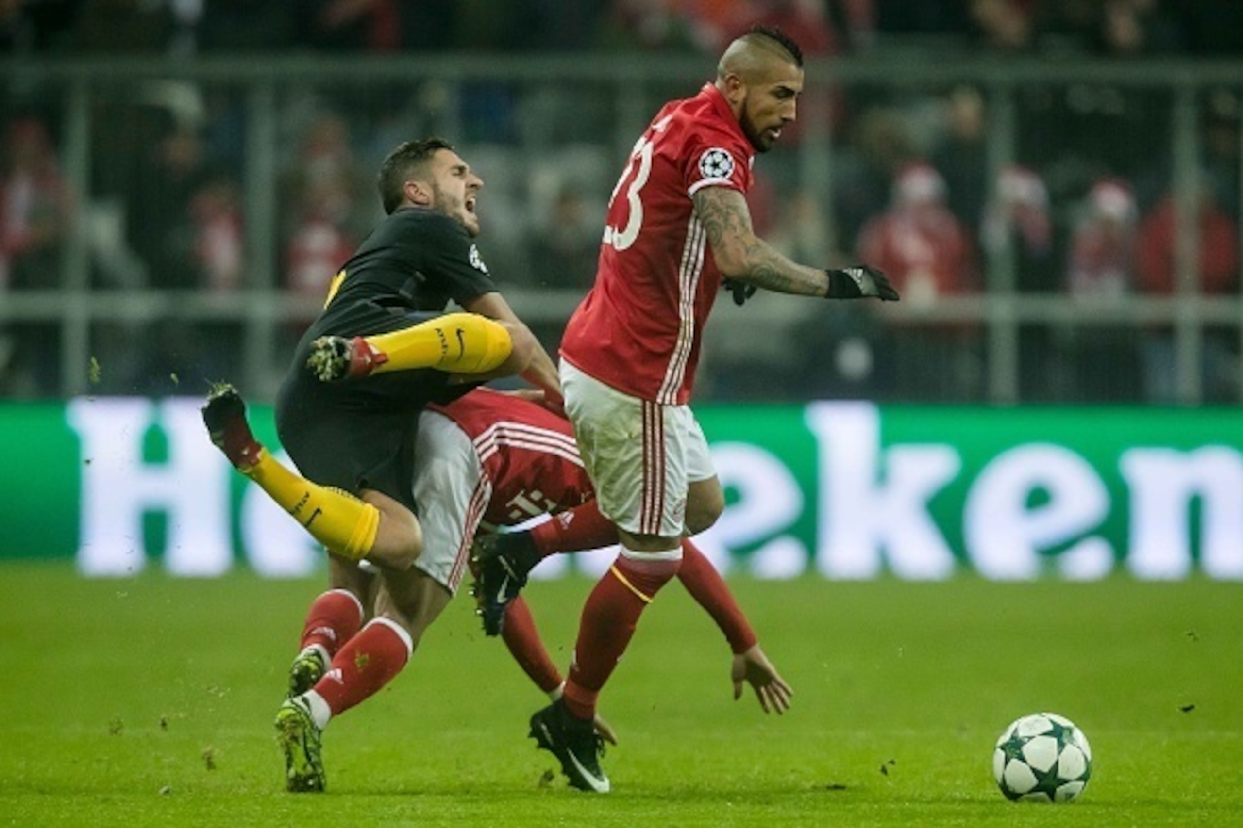 MUNICH, GERMANY - DECEMBER 06: Thiago Alcantara of Muenchen, Arturo Erasmo Vidal of Muenchen und Koke of Atletico Madrid battle for the ball  during the UEFA Champions League match between FC Bayern Muenchen and Club Atletico de Madrid at Allianz Arena on