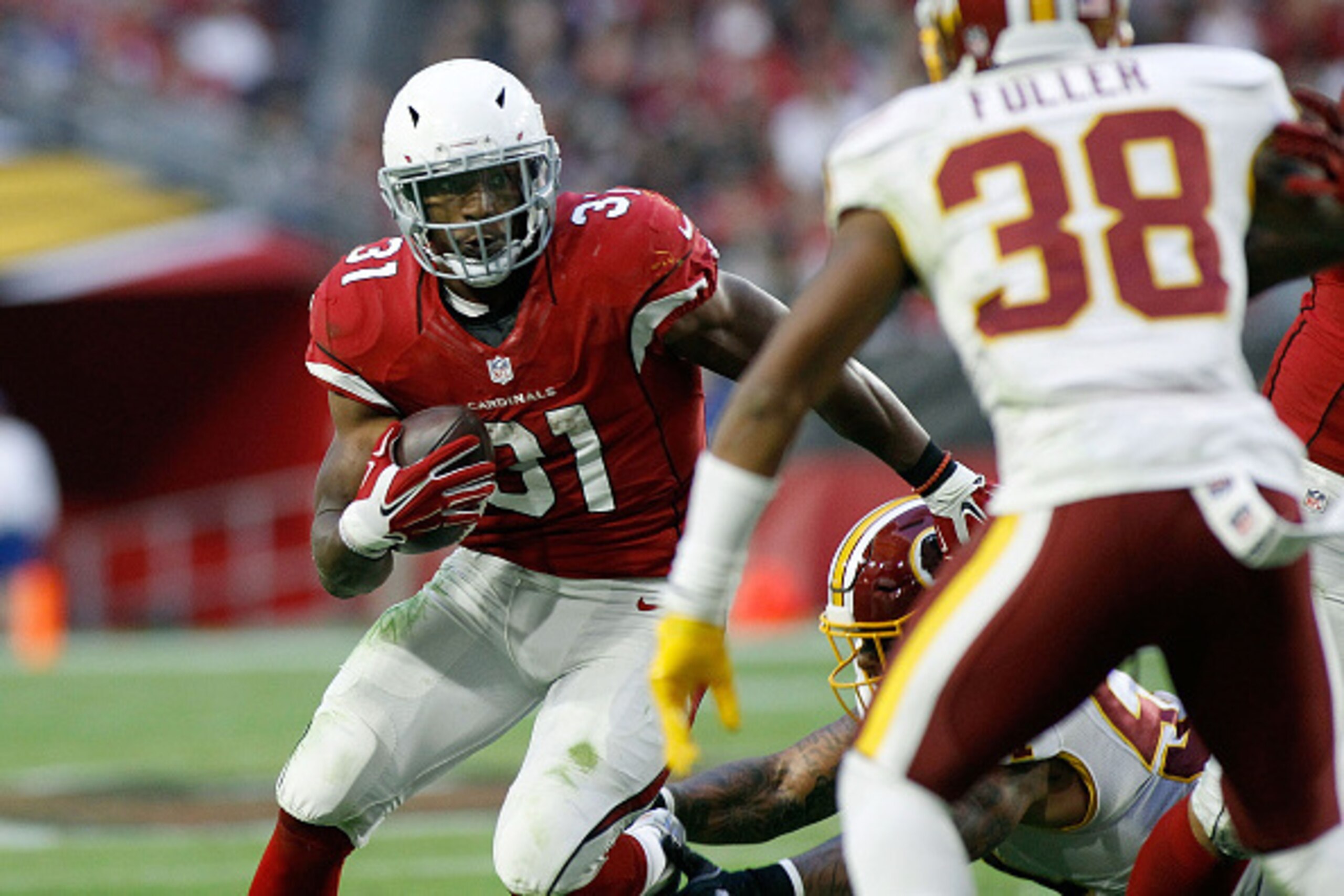 GLENDALE, AZ - DECEMBER 04:  Running back David Johnson #31 of the Arizona Cardinals looks to cut back around Kendall Fuller #38 of the Washington Redskins on a touchdown run during the fourth quarter of a game at University of Phoenix Stadium on December