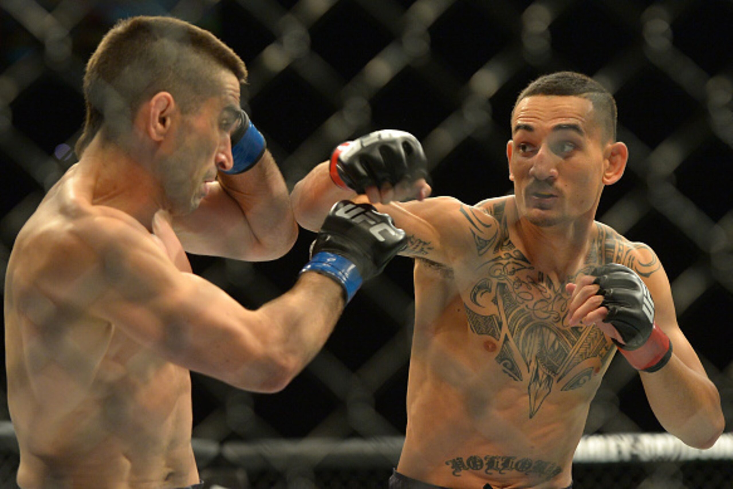INGLEWOOD, CA - JUNE 04: Ricardo Lamas (blue gloves) and Max Holloway (red gloves) during their featherweight bout at UFC 199 at The Forum on June 4, 2016 in Inglewood, California. (Photo by Jayne Kamin-Oncea/Getty Images)