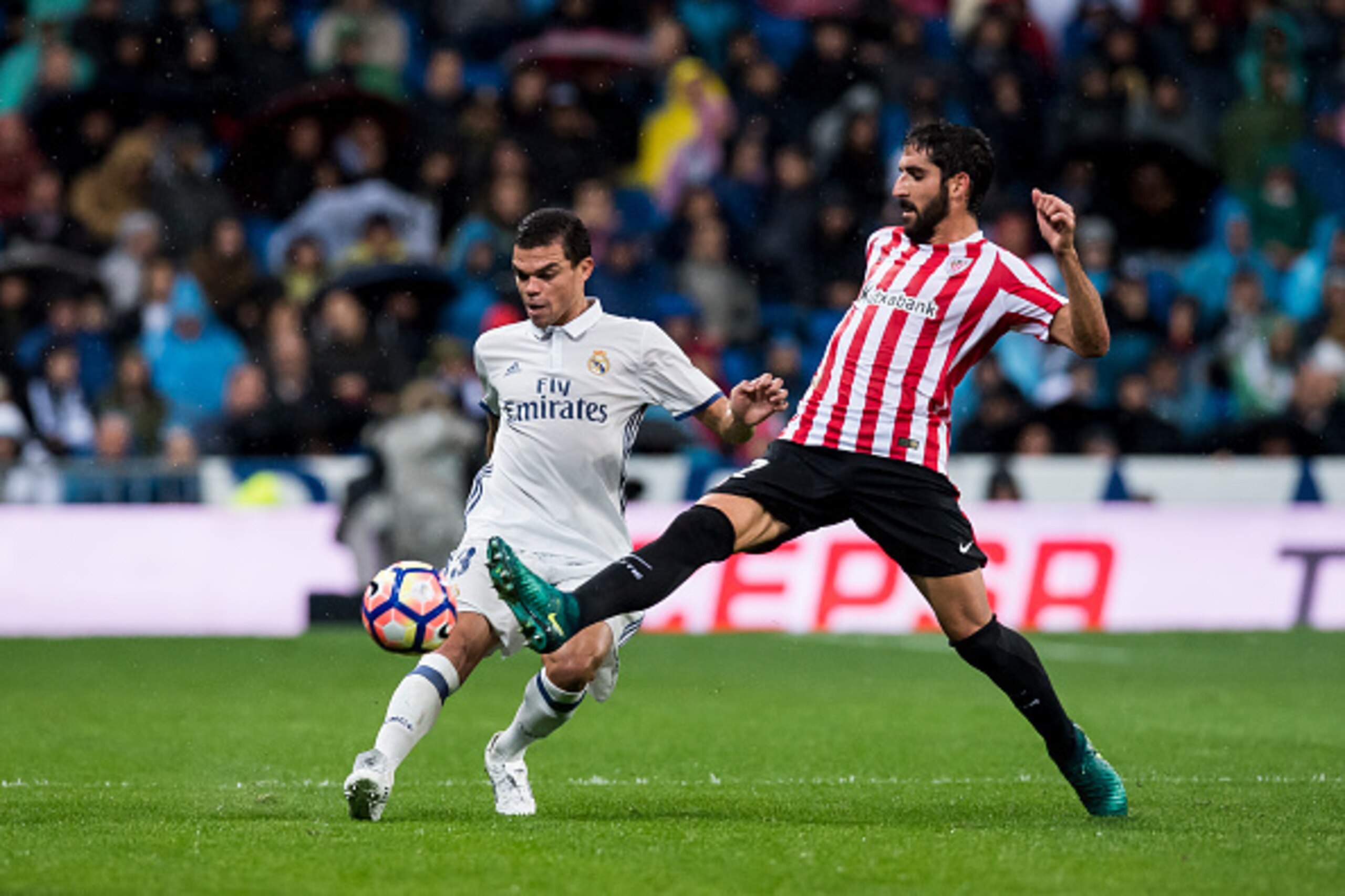 MADRID - OCTOBER 23: Pepe (l) of Real Madrid fights for the ball with Raul Garcia of Athletic Club during their La Liga match between Real Madrid and Athletic Club at the Santiago Bernabeu Stadium on 23 October 2016 in Madrid, Spain. (Photo by Power Sport