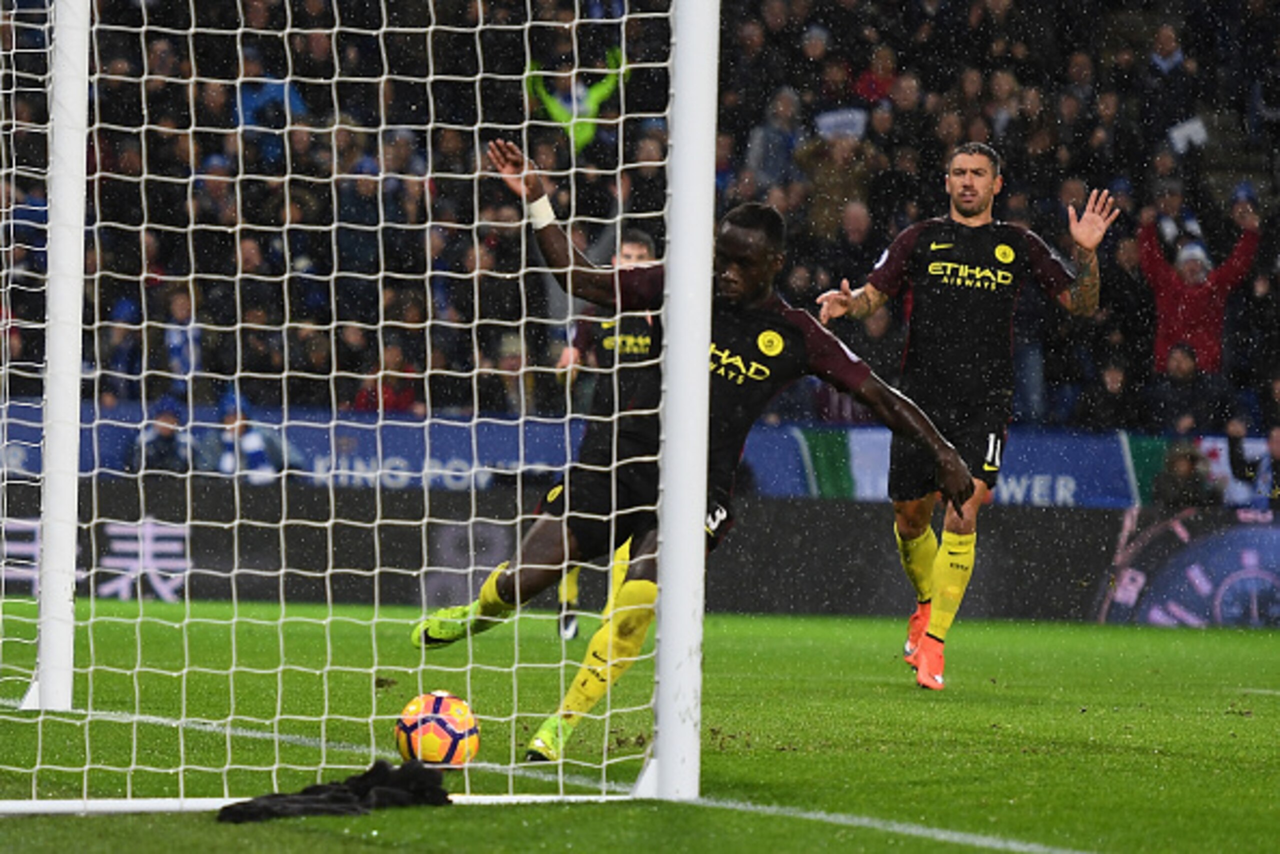 LEICESTER, ENGLAND - DECEMBER 10:  Bacary Sagna of Manchester City (R) attempts to stop the ball, as Jamie Vardy of Leicester City (not pictured) scores his sides fourth goal during the Premier League match between Leicester City and Manchester City at th
