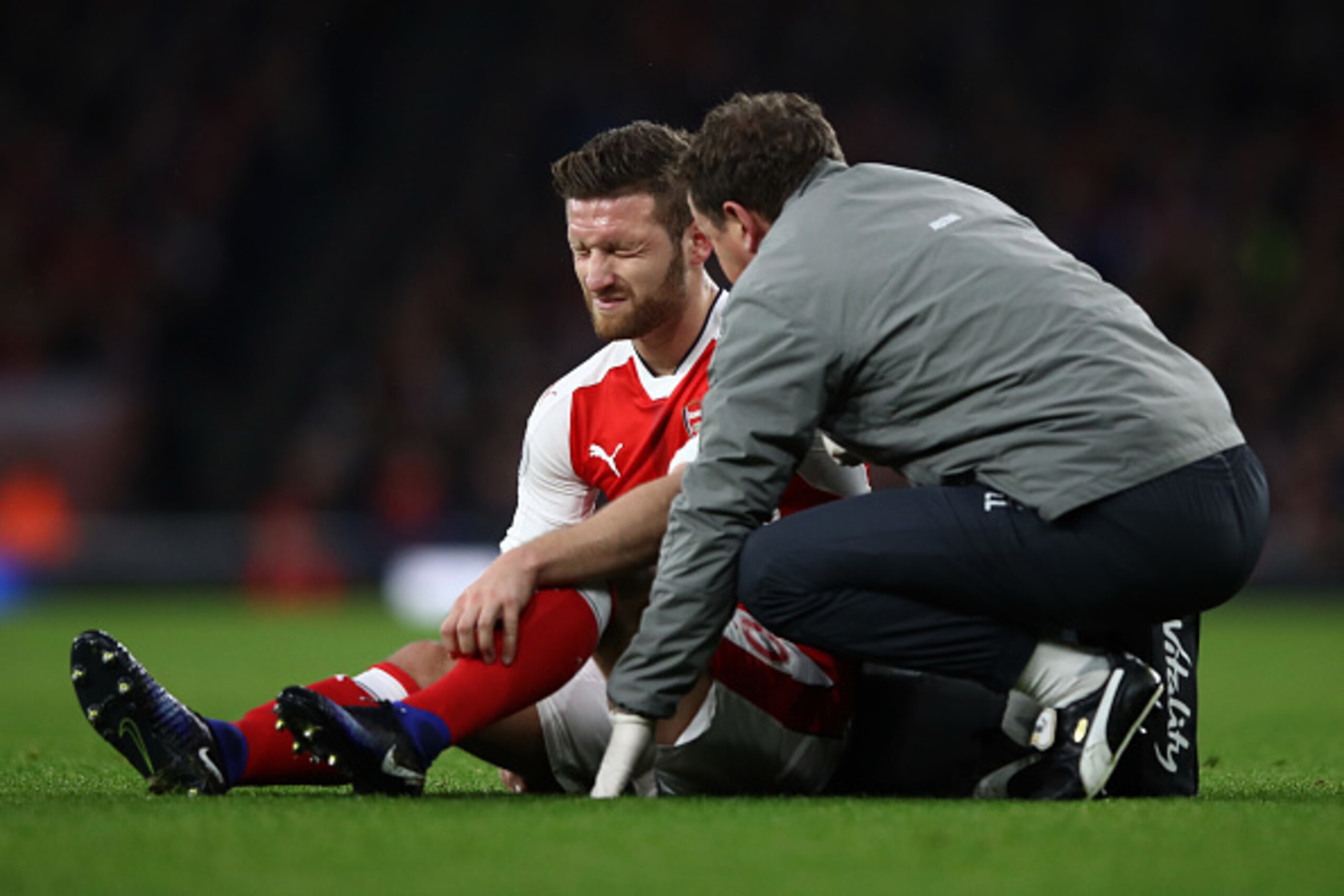 LONDON, ENGLAND - DECEMBER 10: Shkodran Mustafi of Arsenal speaks to a member of the Arsenal medical team after going down injured during the Premier League match between Arsenal and Stoke City at the Emirates Stadium on December 10, 2016 in London, Engla