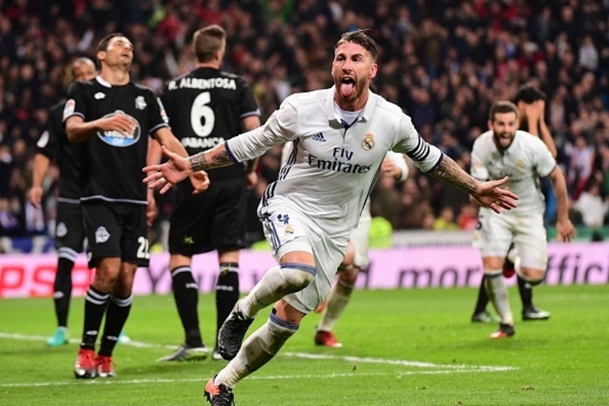 Real Madrid's defender Sergio Ramos celebrates after scoring during the Spanish league football match Real Madrid CF vs RC Deportivo at the Santiago Bernabeu stadium in Madrid on December 10, 2016. / AFP / PIERRE-PHILIPPE MARCOU        (Photo credit shoul