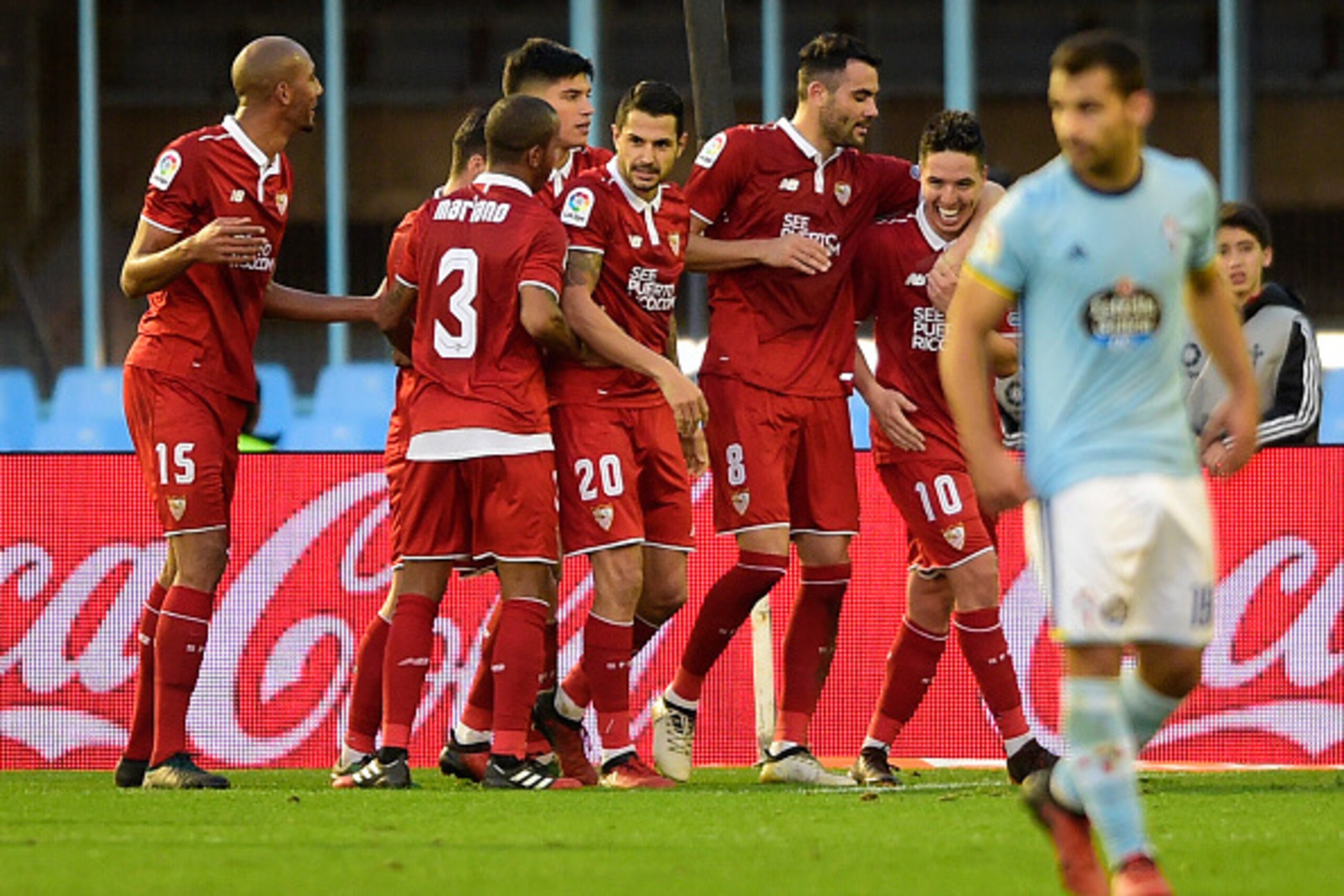 Sevilla's midfielder Vicente Iborra (2ndR) is congratulated by teammates after scoring during the Spanish league football match RC Celta de Vigo vs Sevilla FC at the Balaidos stadium in Vigo on December 11, 2016.
Sevilla won 3-0. / AFP / MIGUEL RIOPA     