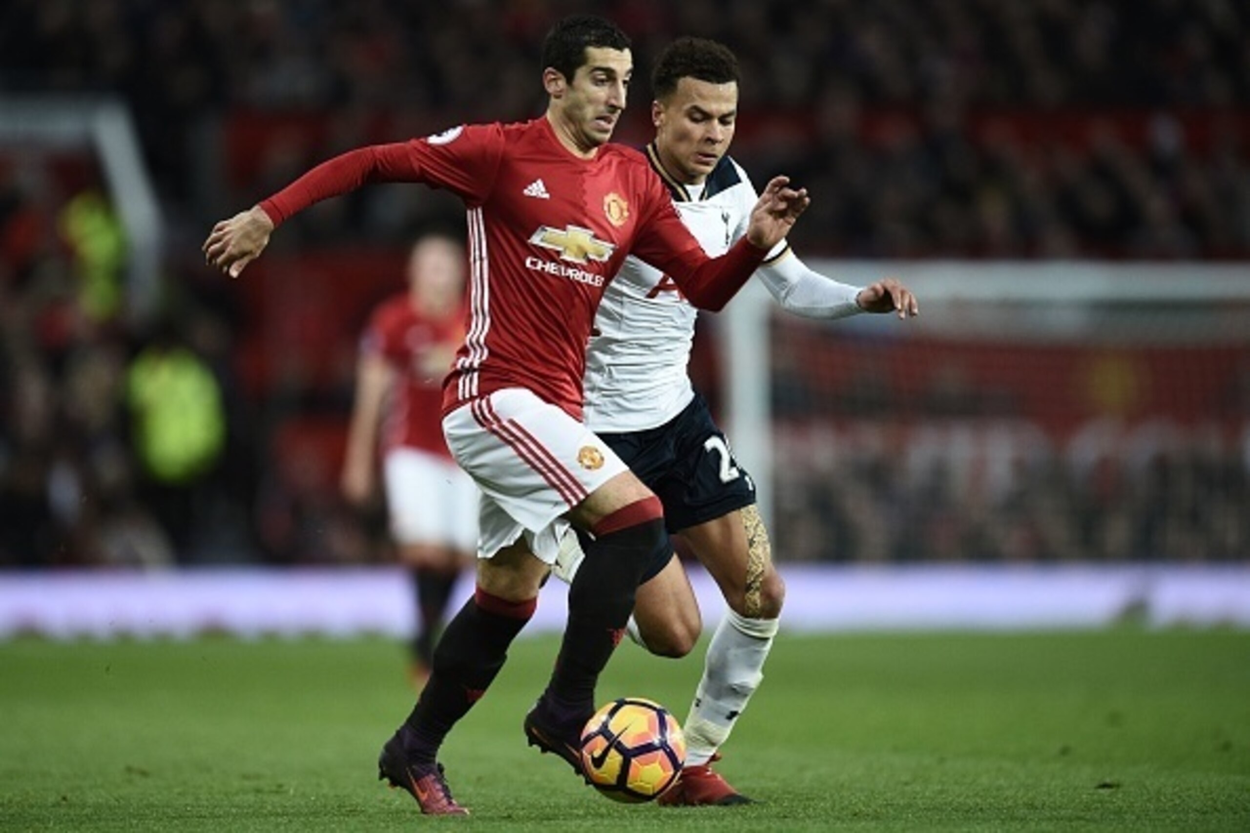 Manchester United's Armenian midfielder Henrikh Mkhitaryan (L) vies with Tottenham Hotspur's English midfielder Dele Alli (R) during the English Premier League football match between Manchester United and Tottenham Hotspur at Old Trafford in Manchester, n