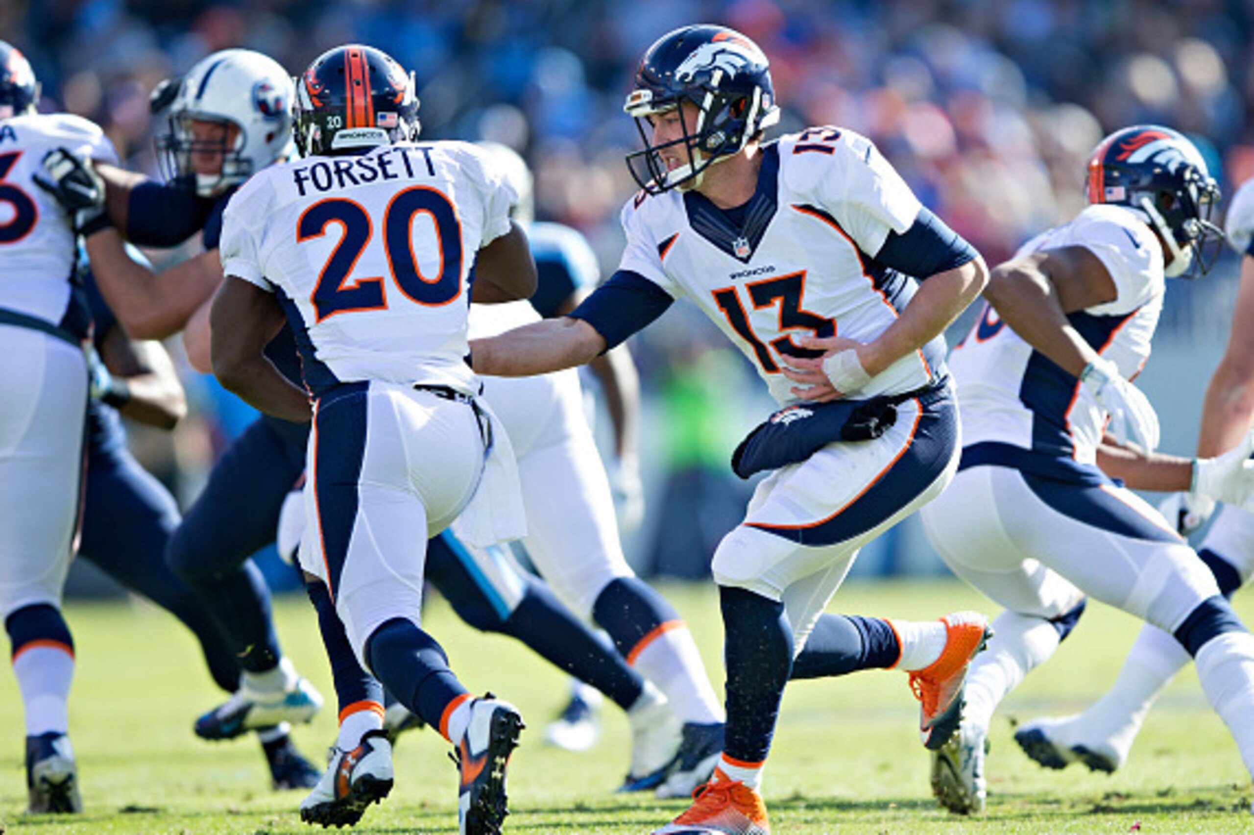 NASHVILLE, TN - DECEMBER 11:  Trevor Siemian #13 hands off the ball to Justin Forsett #20 of the Denver Broncos during a game against the Tennessee Titans at Nissan Stadium on December 11, 2016 in Nashville, Tennessee.  The Titans defeated the Broncos 13-