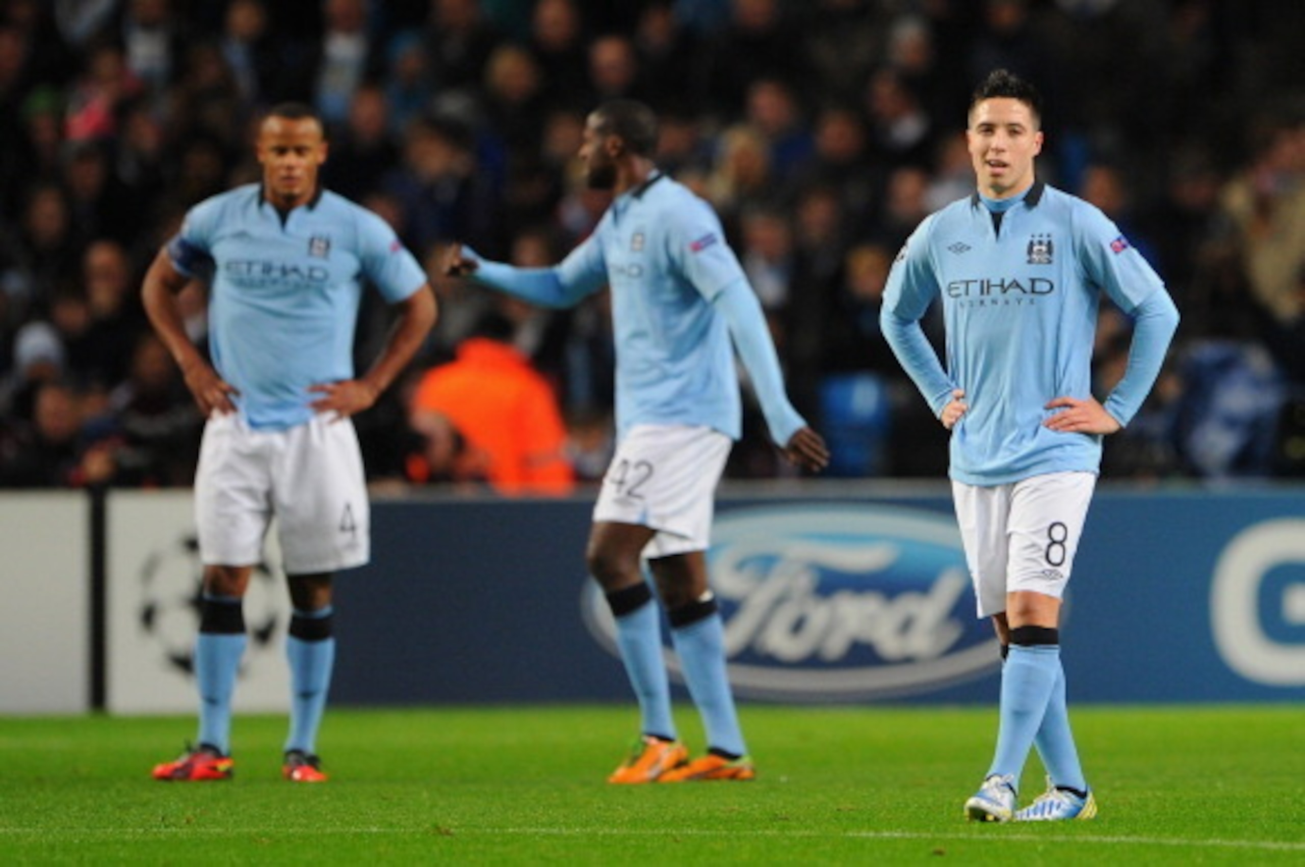 MANCHESTER, ENGLAND - NOVEMBER 21:  Samir Nasri of Manchester City and his team-mates look dejected after conceding the opening goal during the UEFA Champions League Group D match between Manchester City FC and Real Madrid CF at the Etihad Stadium on Nove