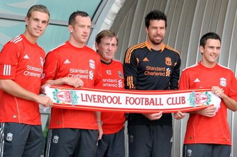 Liverpool's new summer signings Jordan Henderson (L), Charlie Adam, (2nd L) Alexander Doni (2nd R) and Stewart Downing (R) pose for pictures with manager Kenny Dalglish (C) after a press conference at their Melwood Training Ground in Liverpool, north-west