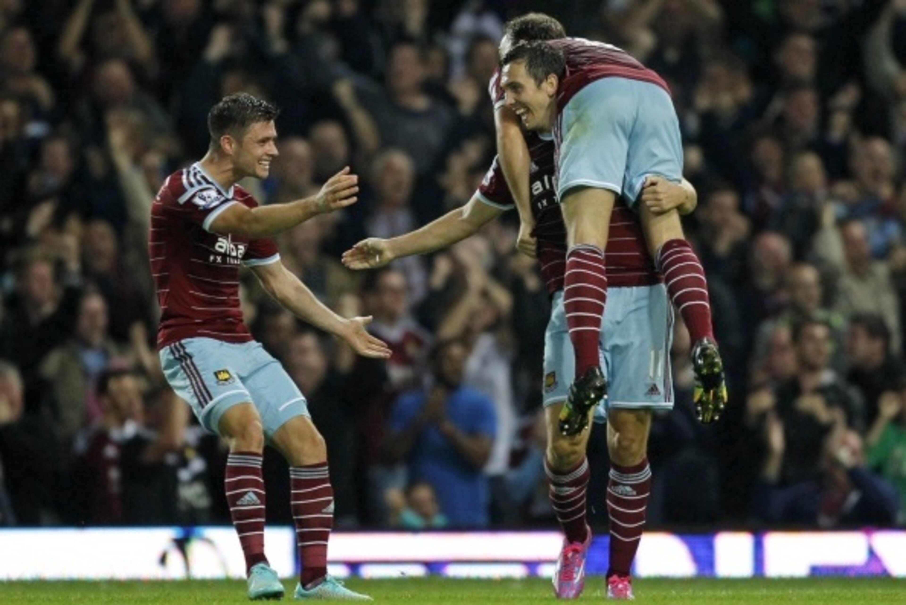West Ham United's English defender Aaron Cresswell (L), West Ham United's English midfielder Stewart Downing and West Ham United's English midfielder Mark Noble (R) celebrate their third goal during the English Premier League football match between West H West Ham United's English defender Aaron Cresswell (L), West Ham United's English midfielder Stewart Downing and West Ham United's English midfielder Mark Noble (R) celebrate their third goal during the English Premier League football match between West H