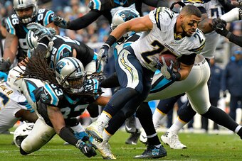 CHARLOTTE, NC - DECEMBER 11:  Kenneth Farrow #27 of the San Diego Chargers loses his helmet and keeps running against Tre Boston #33 of the Carolina Panthers in the 3rd quarter during the game at Bank of America Stadium on December 11, 2016 in Charlotte, 