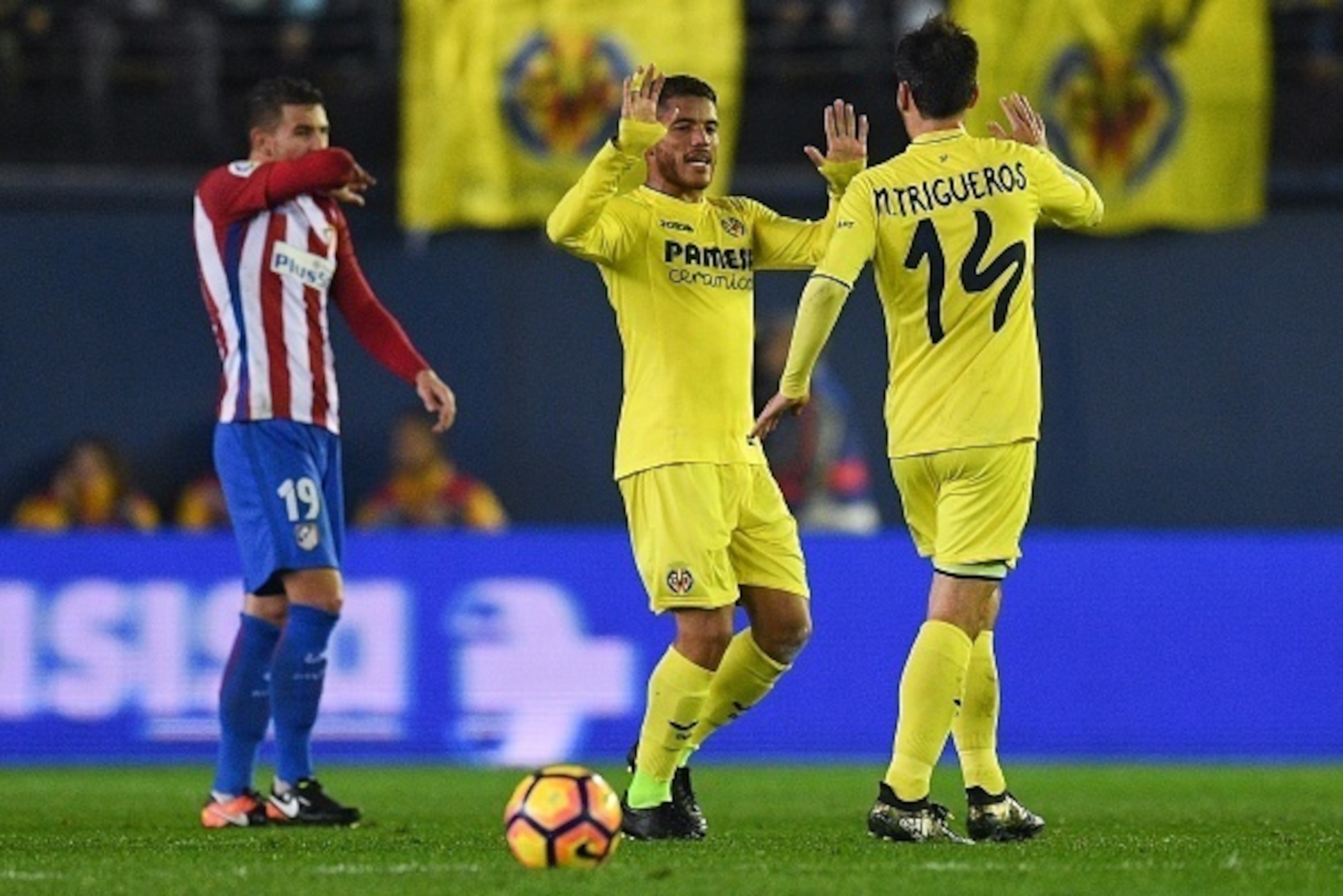 VILLARREAL, SPAIN - DECEMBER 12:  Jonathan dos Santos of Villarreal CF celebrates with his team mate Manu Trigueros after scoring his team's second goal during the La Liga match between Villarreal CF and Club Atletico de Madrid at El Madrigal stadium on D