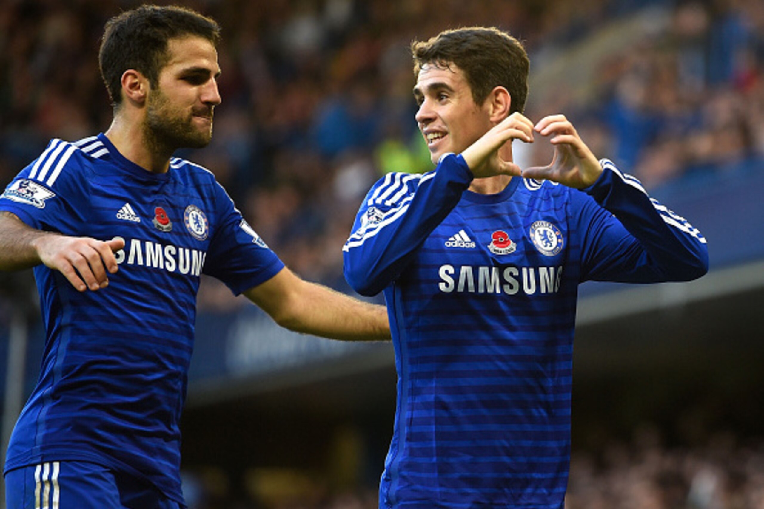 LONDON, ENGLAND - NOVEMBER 01:  Oscar of Chelsea celebrates his goal with Cesc Fabregas during the Barclays Premier League match between Chelsea and Queens Park Rangers at Stamford Bridge on November 1, 2014 in London, England.  (Photo by Mike Hewitt/Gett