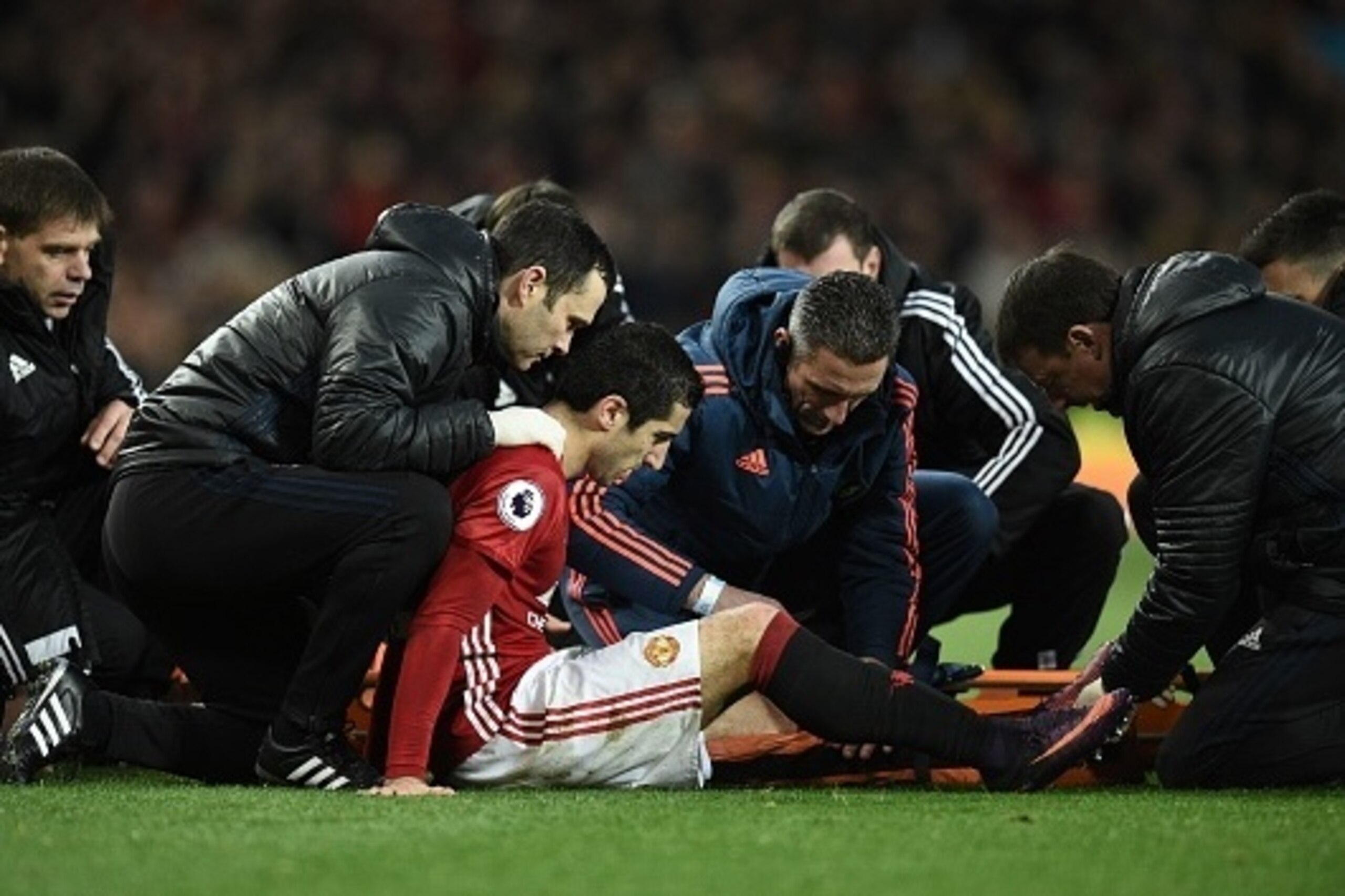 Manchester United's Armenian midfielder Henrikh Mkhitaryan receives medical attention after picking up an injury during the English Premier League football match between Manchester United and Tottenham Hotspur at Old Trafford in Manchester, north west Eng