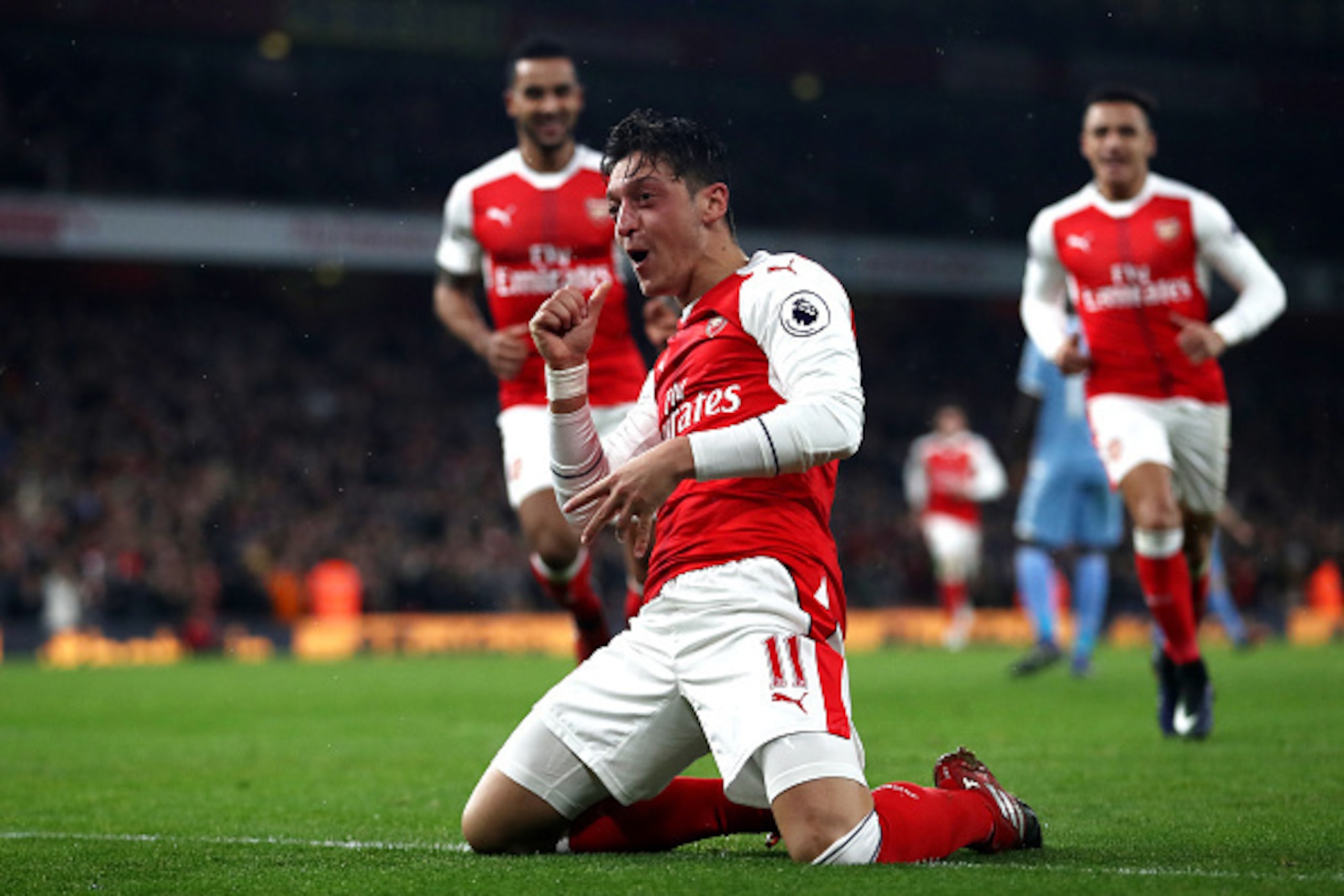 LONDON, ENGLAND - DECEMBER 10: Mesut Ozil of Arsenal celebrates scoring his sides first goal during the Premier League match between Arsenal and Stoke City at the Emirates Stadium on December 10, 2016 in London, England.  (Photo by Julian Finney/Getty Ima
