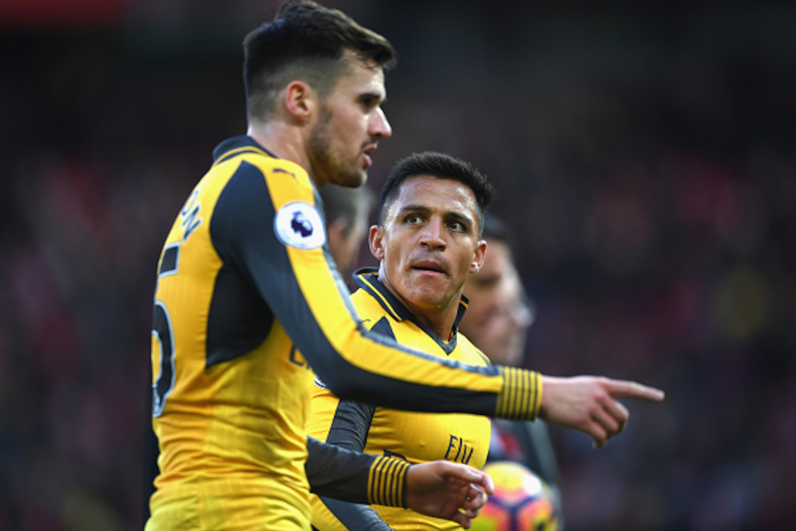 MANCHESTER, ENGLAND - NOVEMBER 19:  Alexis Sanchez of Arsenal (R) speaks to Carl Jenkinson of Arsenal (L) during the Premier League match between Manchester United and Arsenal at Old Trafford on November 19, 2016 in Manchester, England.  (Photo by Shaun B