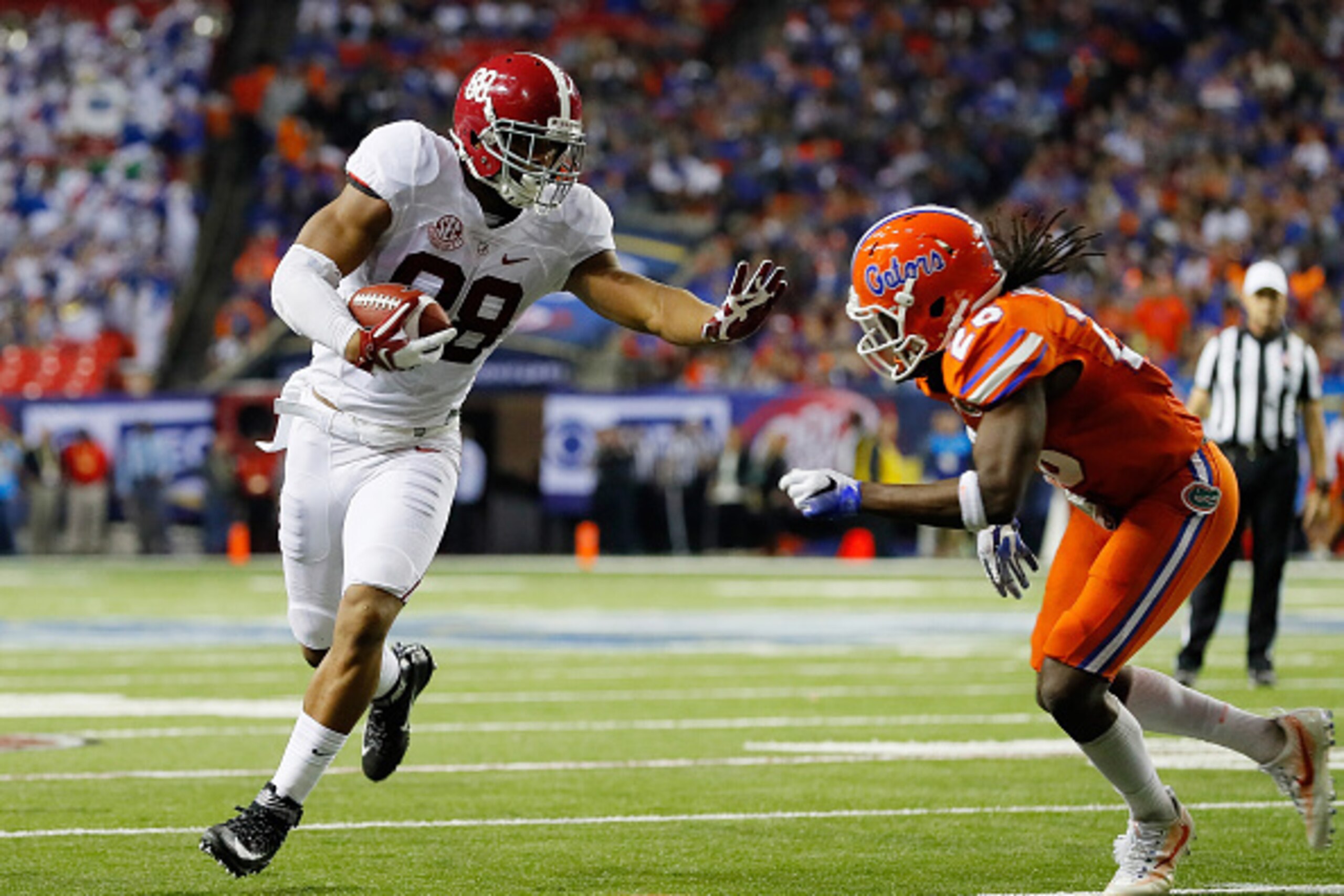 ATLANTA, GA - DECEMBER 03:  Marcell Harris #26 of the Florida Gators tackles O.J. Howard #88 of the Alabama Crimson Tide in the first half during the SEC Championship game at the Georgia Dome on December 3, 2016 in Atlanta, Georgia.  (Photo by Kevin C. Co