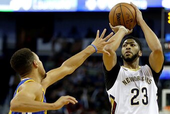 NEW ORLEANS, LA - DECEMBER 13:  Anthony Davis #23 of the New Orleans Pelicans scores a three pointer over Stephen Curry #30 of the Golden State Warriors during the first half at the Smoothie King Center on December 13, 2016 in New Orleans, Louisiana. NOTE