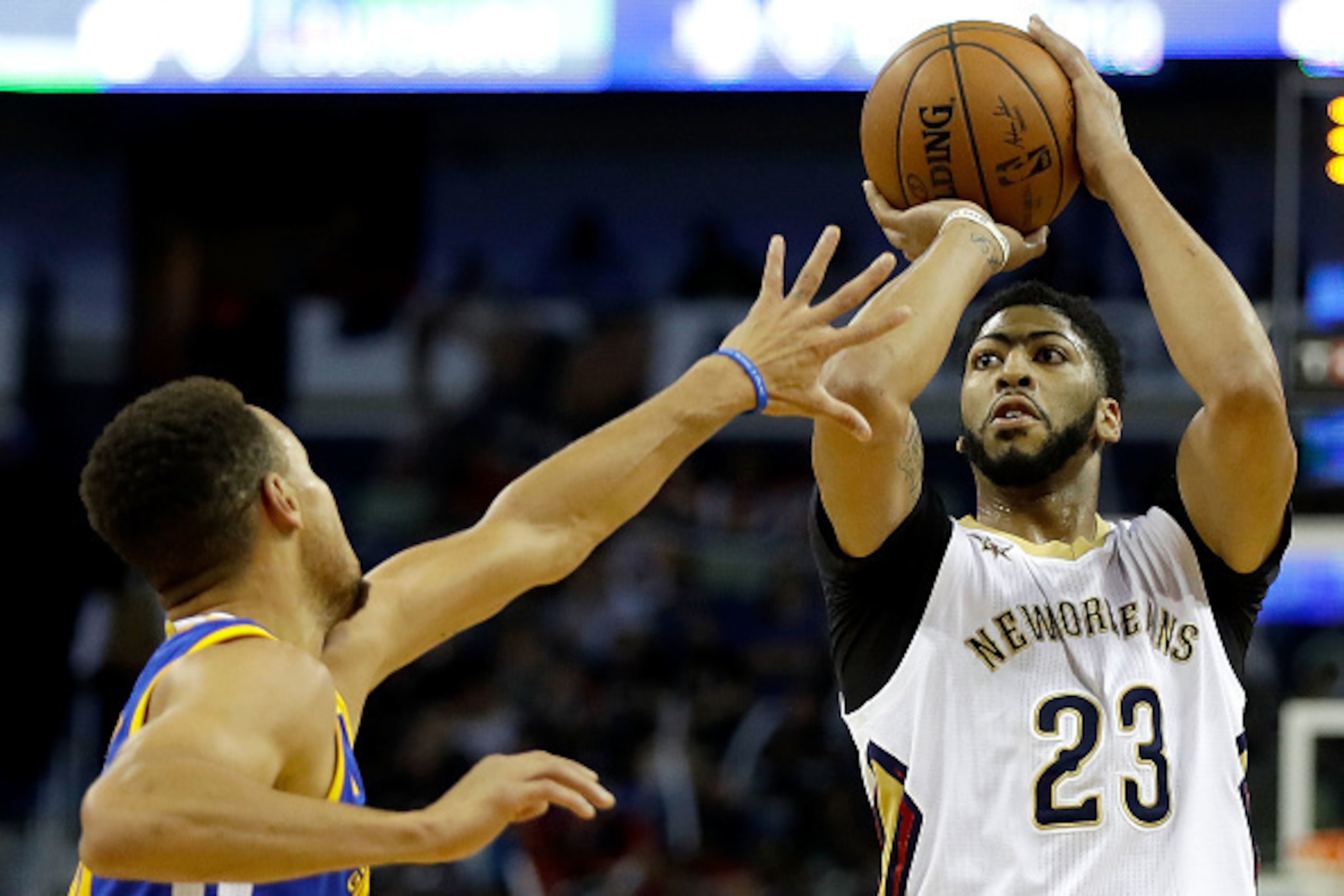 NEW ORLEANS, LA - DECEMBER 13:  Anthony Davis #23 of the New Orleans Pelicans scores a three pointer over Stephen Curry #30 of the Golden State Warriors during the first half at the Smoothie King Center on December 13, 2016 in New Orleans, Louisiana. NOTE