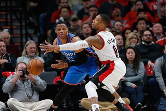 PORTLAND, OR - DECEMBER 13:  Russell Westbrook #0 of the Oklahoma City Thunder is guarded by Damian Lillard #0 of the Portland Trail Blazers  at Moda Center on December 13, 2016 in Portland, Oregon. NOTE TO USER: User expressly acknowledges and agrees tha