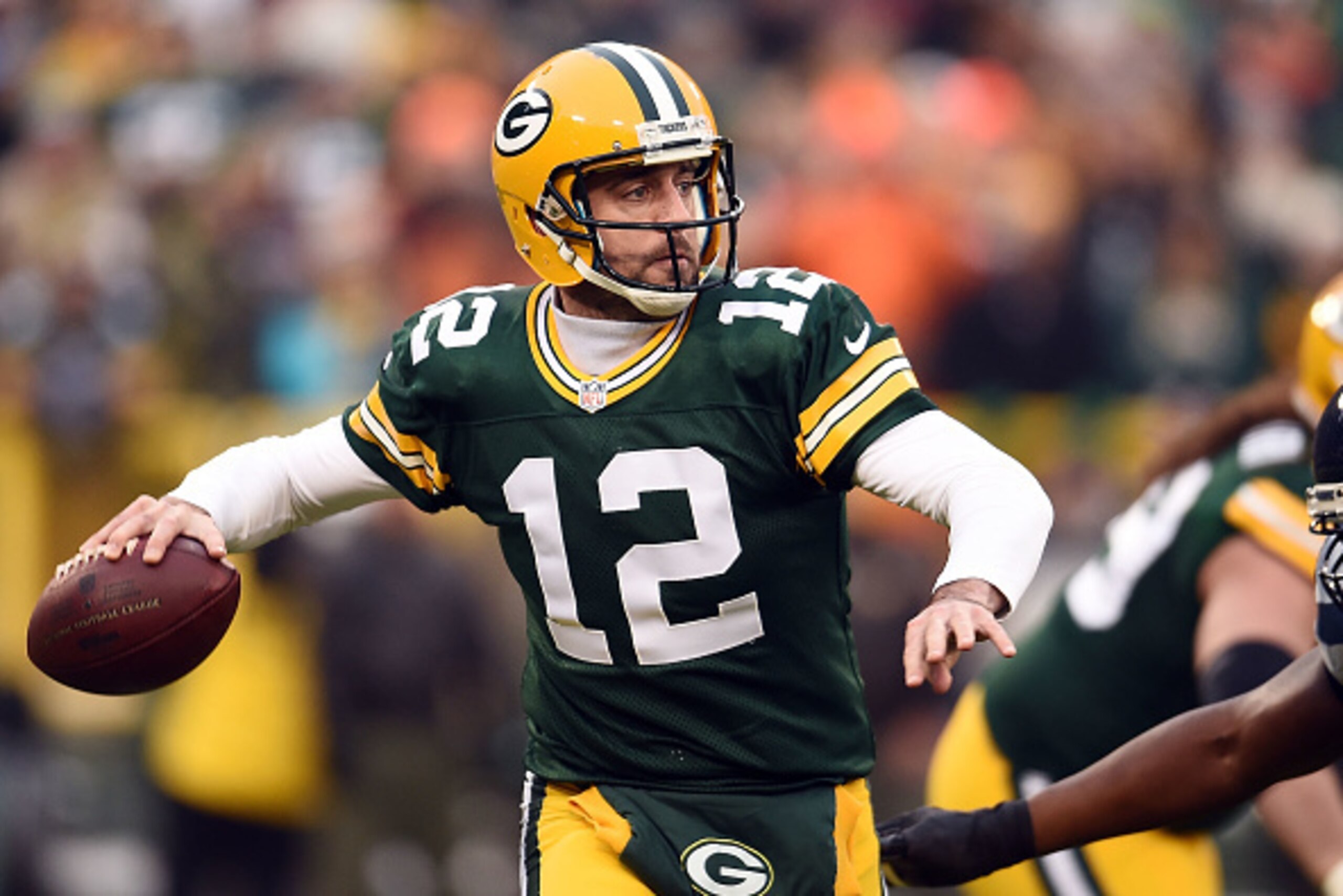 GREEN BAY, WI - DECEMBER 11:  Aaron Rodgers #12 of the Green Bay Packers drops back to pass during a game against the Seattle Seahawks at Lambeau Field on December 11, 2016 in Green Bay, Wisconsin.  The Packers defeated the Seahawks 38-10.  (Photo by Stac