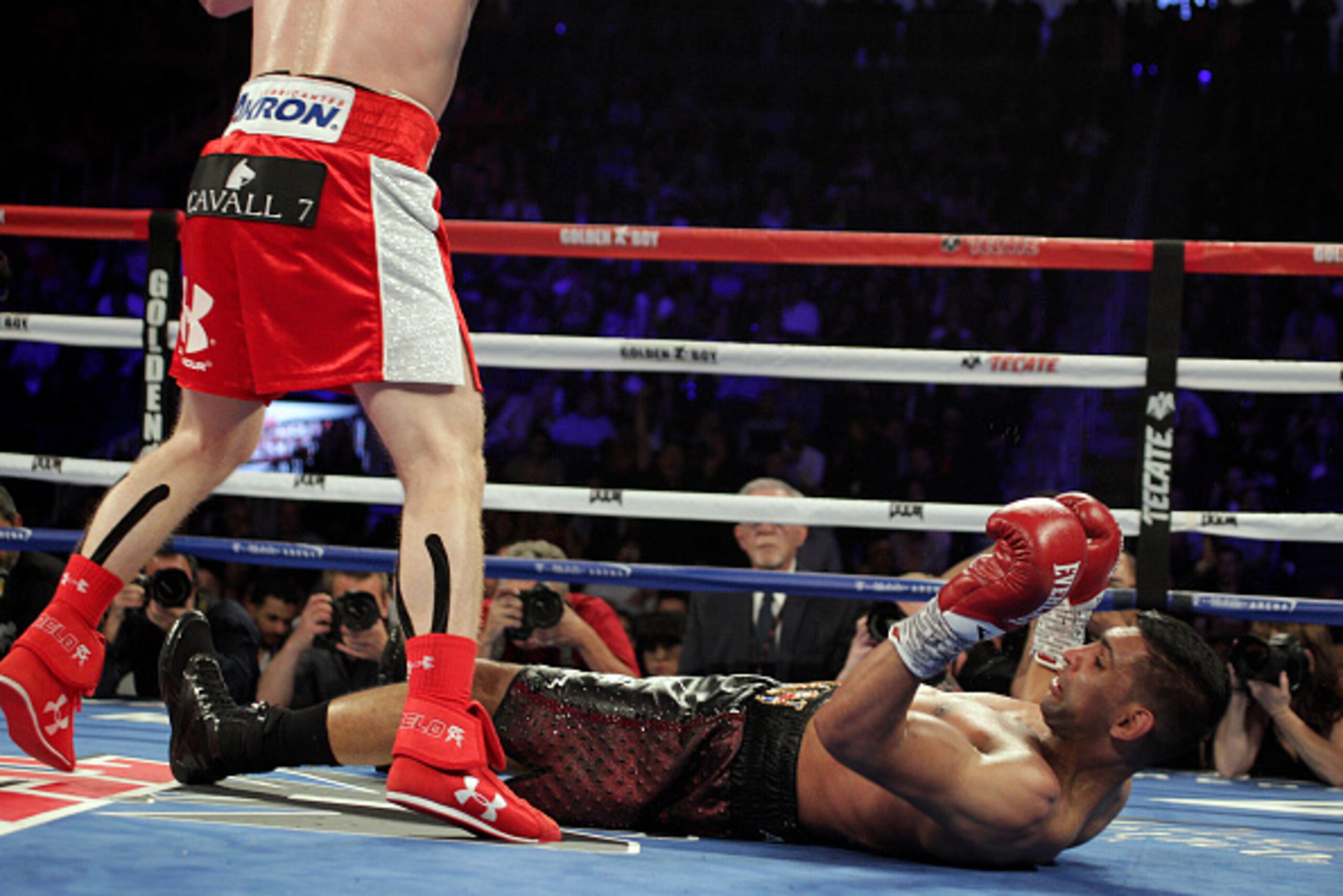 Canelo Alvarez of Mexico stands over the fallen Amir Khan of Great Britain in the sixth round and final round of their WBC middleweight title fight at T-Mobile Arena on May 7, 2016 in Las Vegas, Nevada.
Saul 'Canelo' Alvarez successfully defended his Worl