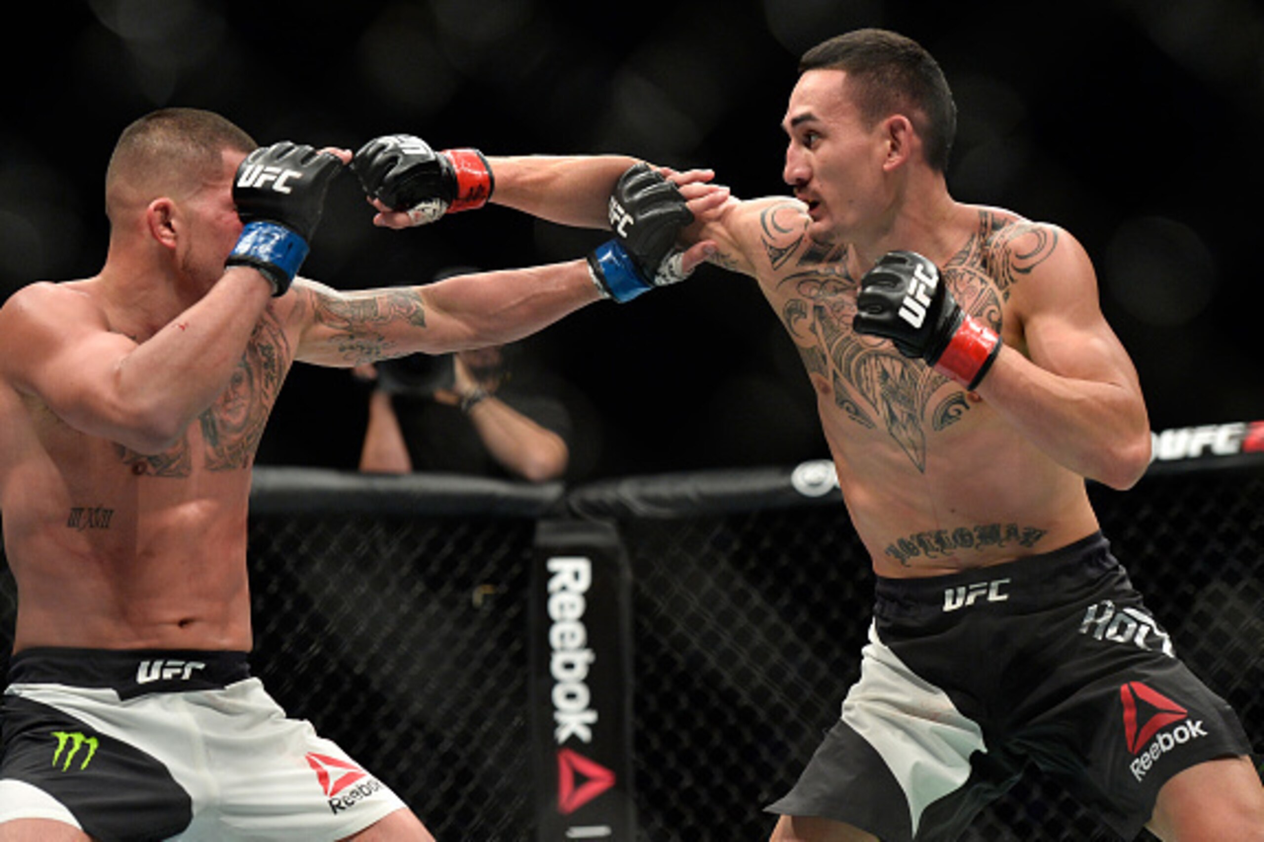 TORONTO, CANADA - DECEMBER 10:  (R-L) Max Holloway punches Anthony Pettis in their interim UFC featherweight championship bout during the UFC 206 event inside the Air Canada Centre on December 10, 2016 in Toronto, Ontario, Canada. (Photo by Brandon Magnus
