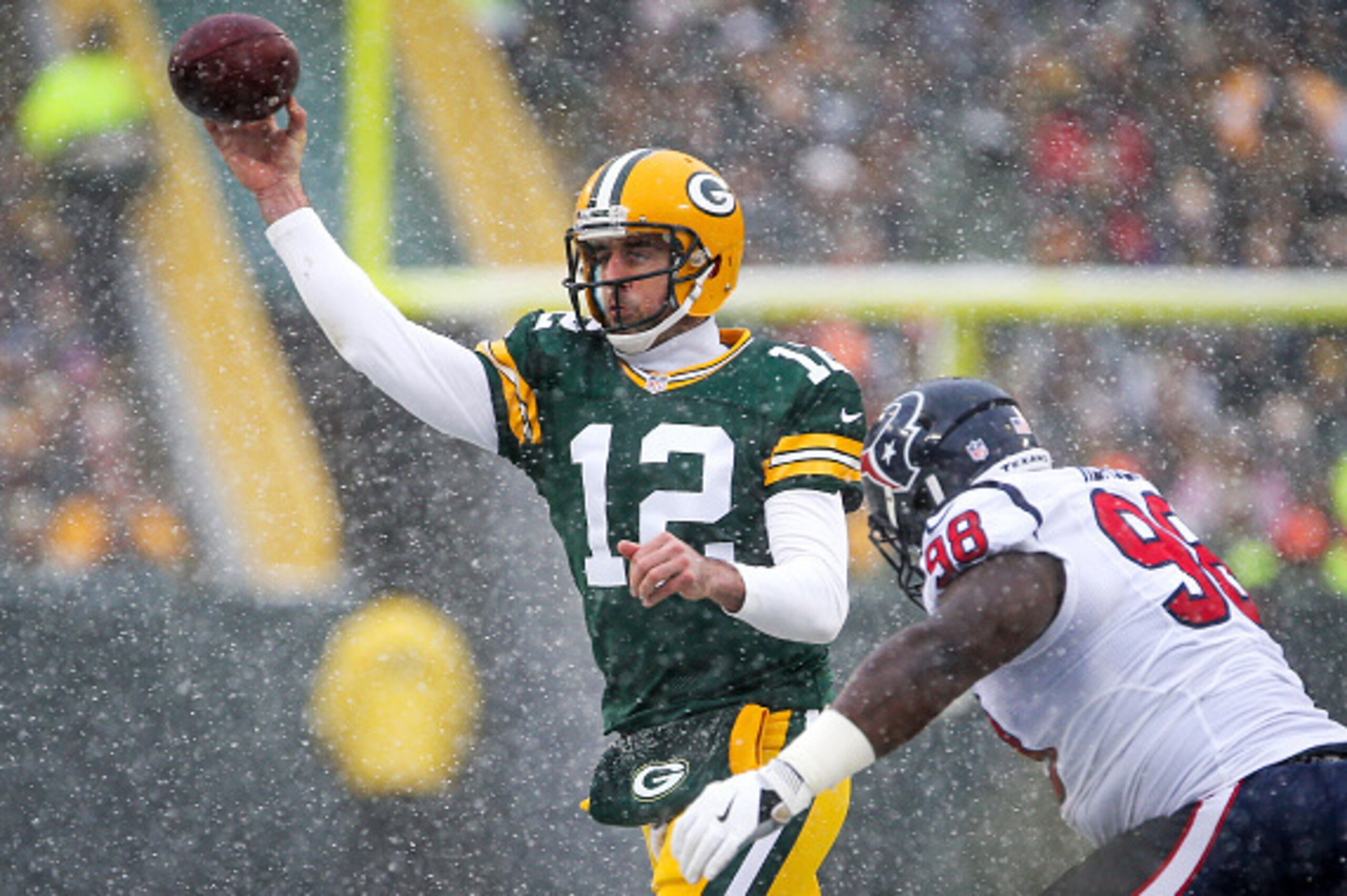 GREEN BAY, WI - DECEMBER 04:  Aaron Rodgers #12 of the Green Bay Packers throws a pass while being pursued by D.J. Reader #98 of the Houston Texans in the second quarter at Lambeau Field on December 4, 2016 in Green Bay, Wisconsin. (Photo by Dylan Buell/G