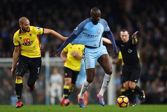 MANCHESTER, ENGLAND - DECEMBER 14: Adlene Guedioura of Watford (L) pulls on Yaya Toure of Manchester City (R) shirt during the Premier League match between Manchester City and Watford at Etihad Stadium on December 14, 2016 in Manchester, England.  (Photo 
