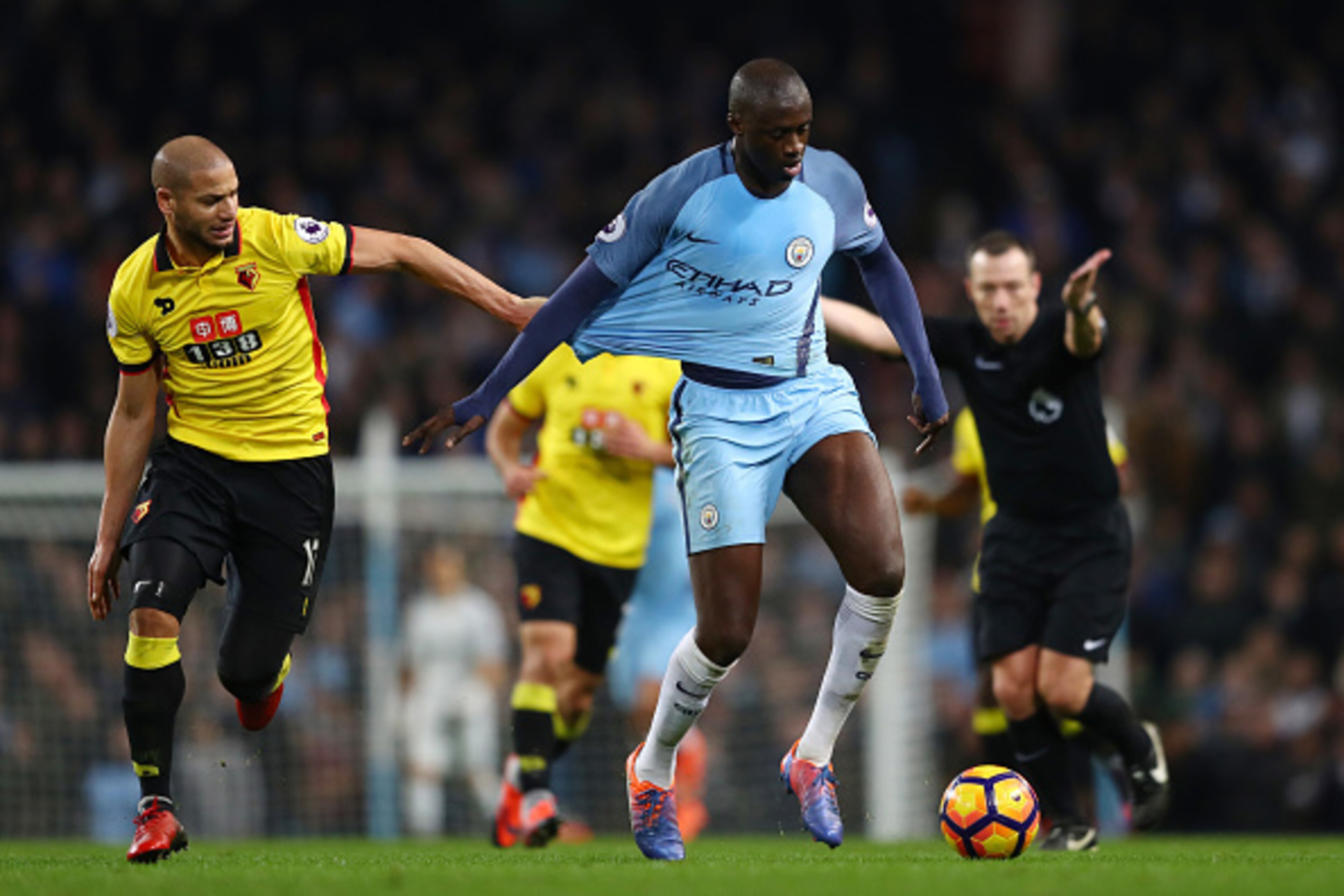 MANCHESTER, ENGLAND - DECEMBER 14: Adlene Guedioura of Watford (L) pulls on Yaya Toure of Manchester City (R) shirt during the Premier League match between Manchester City and Watford at Etihad Stadium on December 14, 2016 in Manchester, England.  (Photo 