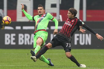MILAN, ITALY - DECEMBER 04:  Marcello Trotta of FC Crotone competes for the ball with Manuel Locatelli of AC Milan during the Serie A match between AC Milan and FC Crotone at Stadio Giuseppe Meazza on December 4, 2016 in Milan, Italy.  (Photo by Marco Luz