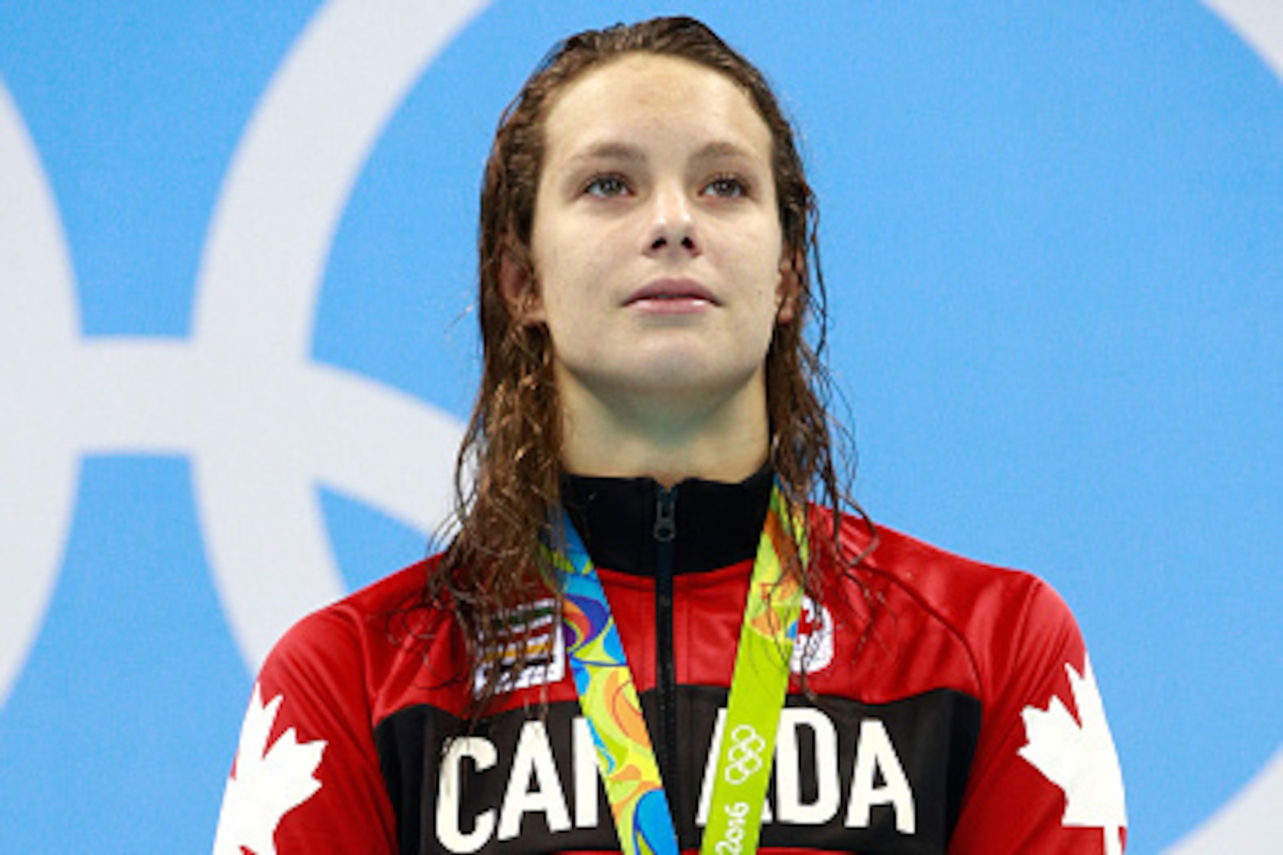 RIO DE JANEIRO, BRAZIL - AUGUST 11:  Gold medalist Penny Oleksiak of Canada celebrates on the podium during the medal ceremony for the Women's 100m Freestyle Final on Day 6 of the Rio 2016 Olympic Games at the Olympic Aquatics Stadium on August 11, 2016 i