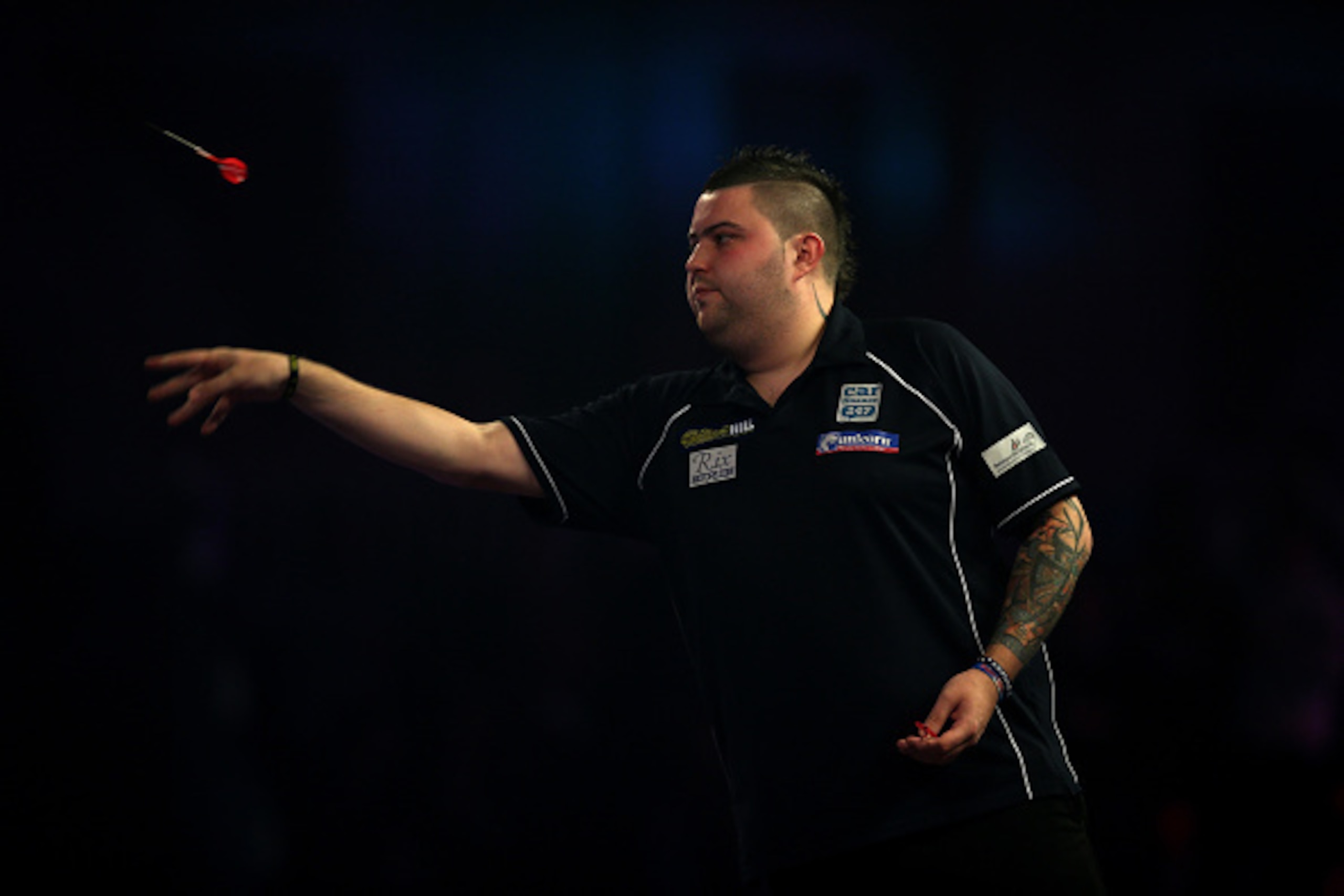 LONDON, ENGLAND - DECEMBER 15:  Michael Smith of England throws during his first round match against Ricky Evans of England during day one of the 2017 William Hill PDC World Darts Championships at Alexandra Palace on December 15, 2016 in London, England. 