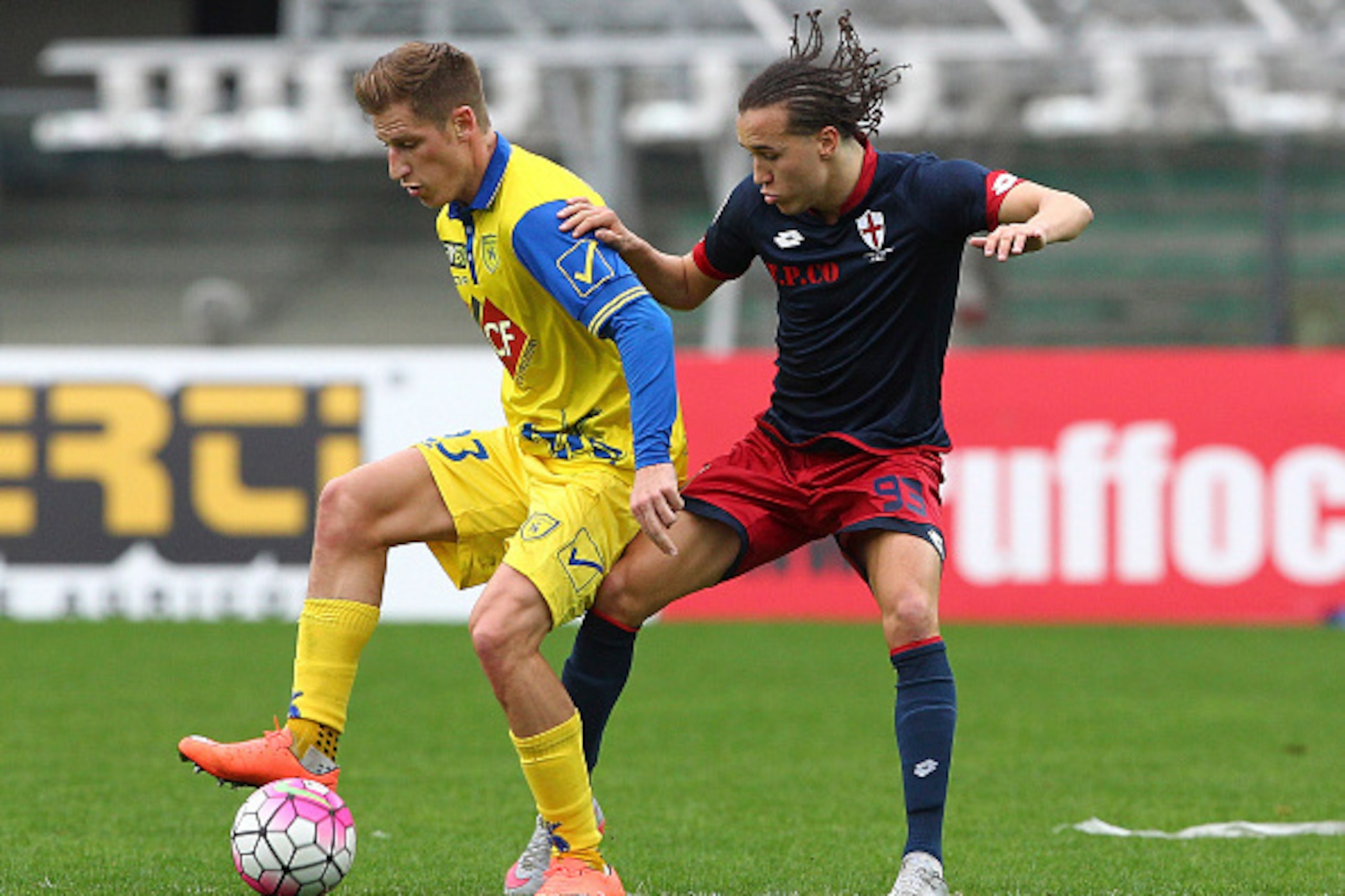 VERONA, ITALY - FEBRUARY 28:  Valter Birsa of AC Chievo Verona competes for the ball with Diego Laxalt of Genoa CFC during the Serie A match between AC Chievo Verona and Genoa CFC at Stadio Marc'Antonio Bentegodi on February 28, 2016 in Verona, Italy.  (P