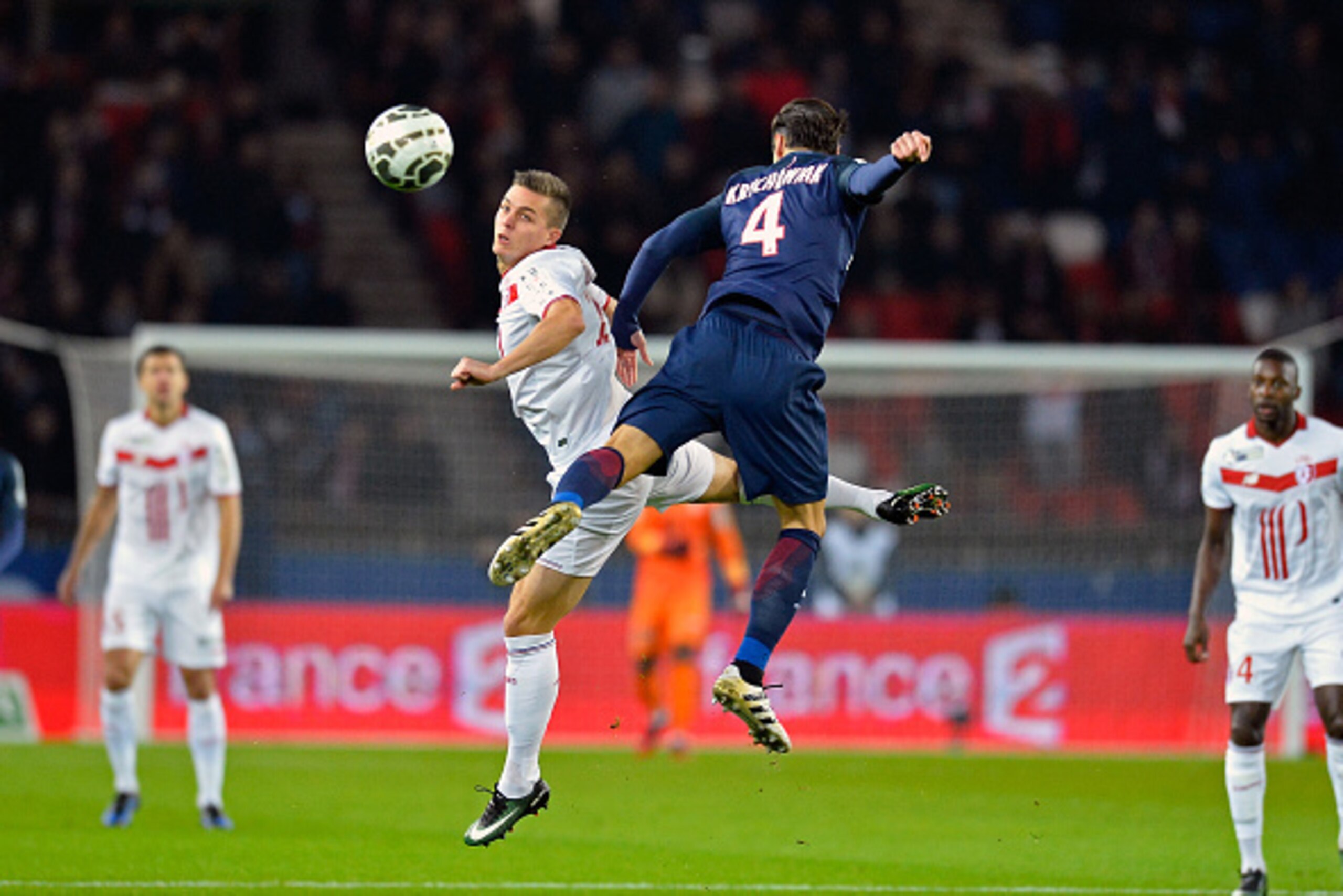 PARIS, FRANCE - DECEMBER 14:  Grzegorz Krychowiak of Paris Saint-Germain and Nicolas De Preville of Lille LOSC fight for the ball during the French League Cup match between Paris Saint-Germain and Lille LOSC on December 14, 2016 in Paris, France.  (Photo 