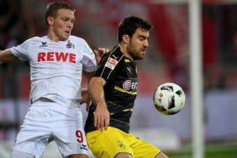 Cologne's Latvian striker Artjoms Rudnevs (L) and Dortmund's Greek defender Sokratis vie for the ball during the German first division Bundesliga football match of 1.FC Cologne vs Borussia Dortmund in Cologne, western Germany, on December 10, 2016. / AFP 