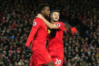 Liverpool's Belgian striker Divock Origi (L) celebrates scoring their second goal to equalise with Liverpool's English midfielder Adam Lallana (R) during the English Premier League football match between Liverpool and West Ham United at Anfield in Liverpo