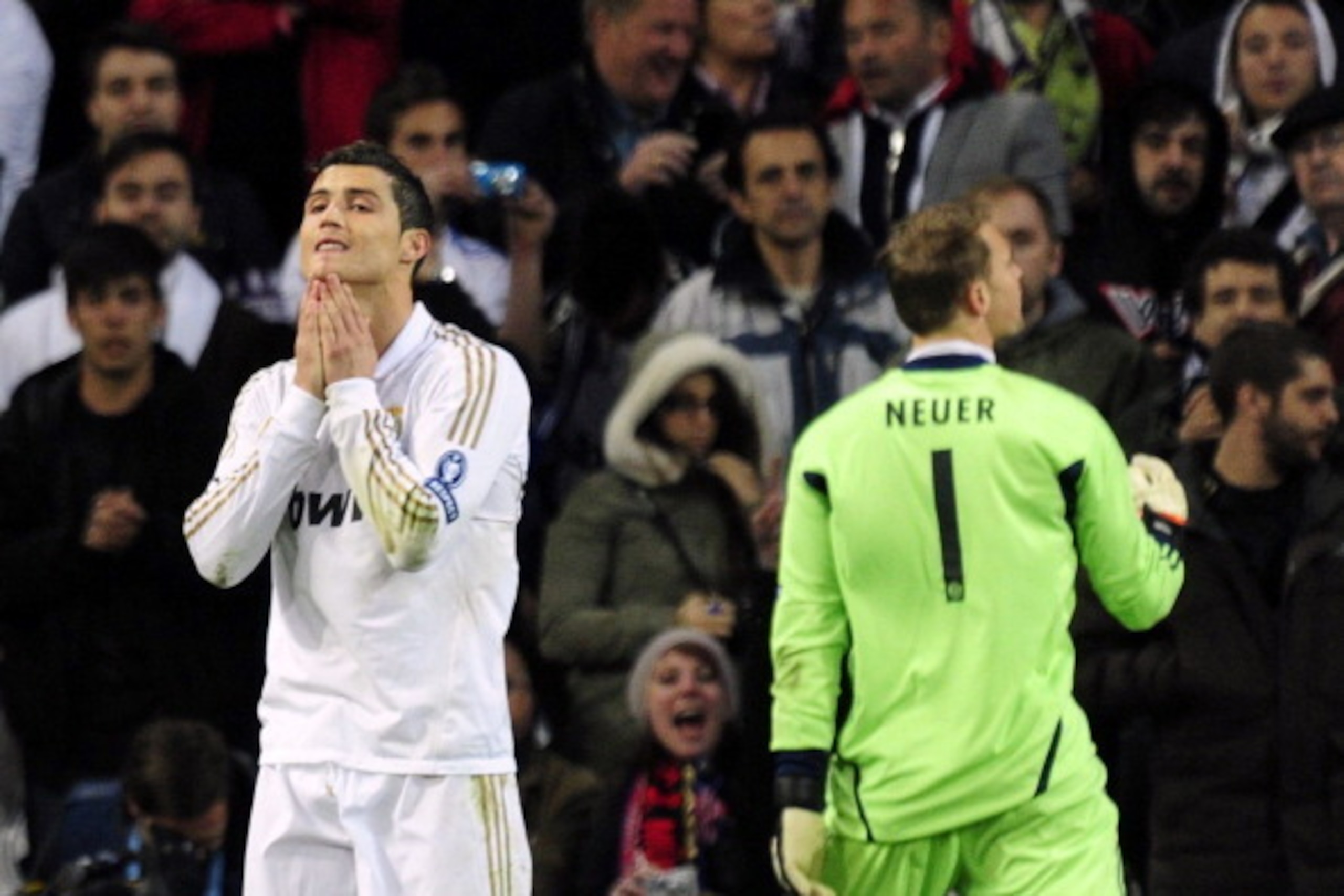 Real Madrid's Portuguese forward Cristiano Ronaldo (L) reacts after missing a penalty against Bayern Munich's goalkeeper Manuel Neuer (R) during the UEFA Champions League second leg semi-final football match Real Madrid against Bayern Munich at the Santia