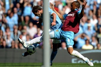 MANCHESTER, ENGLAND - MAY 01:  Daniel Gabbidon of West Ham United tries to stop the shot of Pablo Zabaleta of Manchester City as he scores his team's second goal during the Barclays Premier League match between Manchester City and West Ham United at the C
