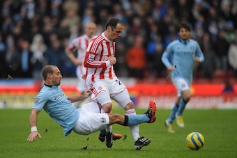STOKE ON TRENT, ENGLAND - JANUARY 26:  Pablo Zabaleta of Man City tackles Matthew Etherington of Stoke City during the FA Cup Fourth Round match between Stoke City and Manchester City at Britannia Stadium on January 26, 2013 in Stoke on Trent, England.  (