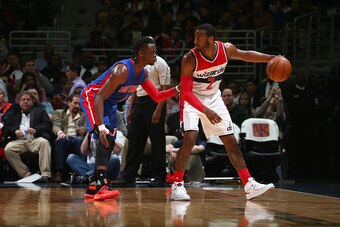 WASHINGTON, DC - FEBRUARY 19:  John Wall #2 of the Washington Wizards handles the ball against Reggie Jackson #1 of the Detroit Pistons on February 19, 2016 at Verizon Center in Washington, DC. NOTE TO USER: User expressly acknowledges and agrees that, by