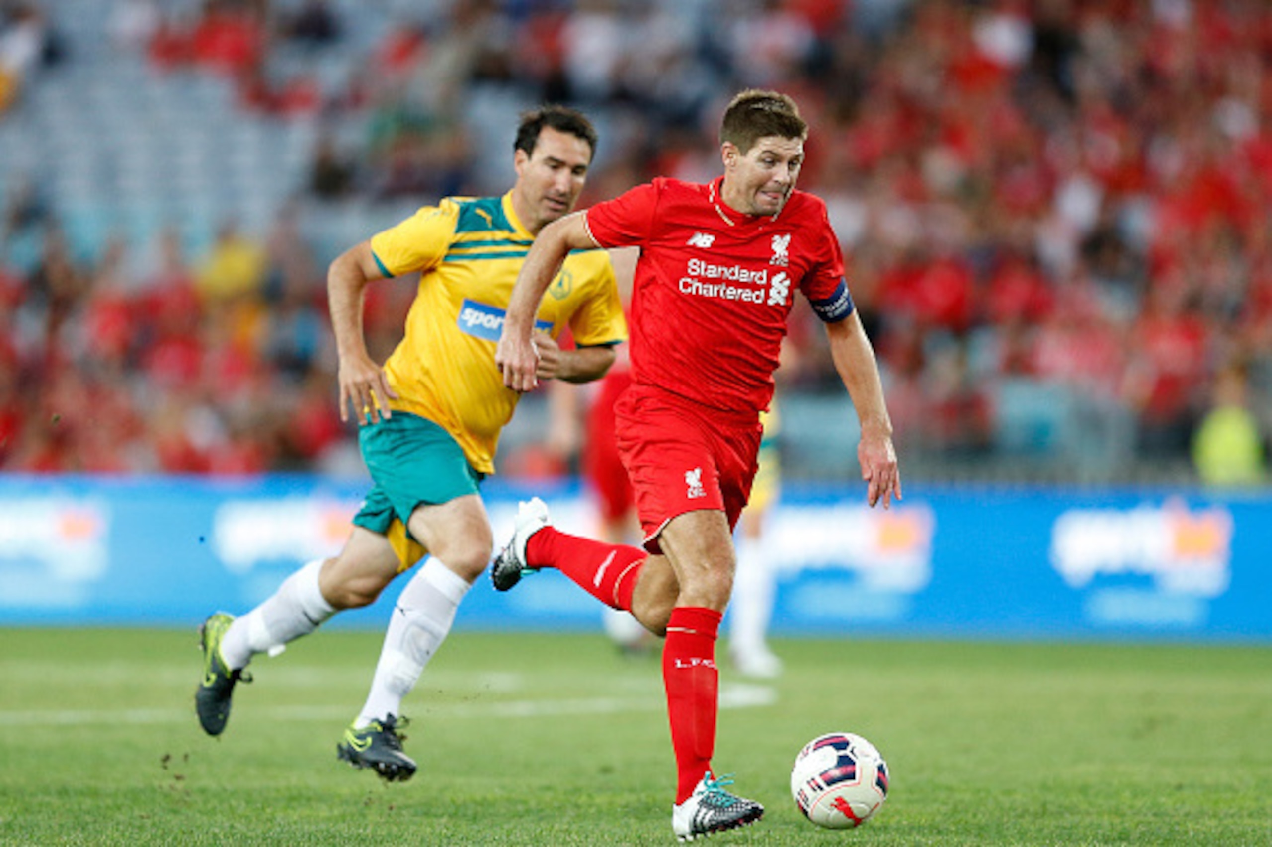 SYDNEY, AUSTRALIA - JANUARY 07: Steven Gerrard of Liverpool FC Legends lbreaks away from Tony Vidmar of Australian Legends during the match between Liverpool FC Legends and the Australian Legends at ANZ Stadium on January 7, 2016 in Sydney, Australia. ( SYDNEY, AUSTRALIA - JANUARY 07: Steven Gerrard of Liverpool FC Legends lbreaks away from Tony Vidmar of Australian Legends during the match between Liverpool FC Legends and the Australian Legends at ANZ Stadium on January 7, 2016 in Sydney, Australia. (