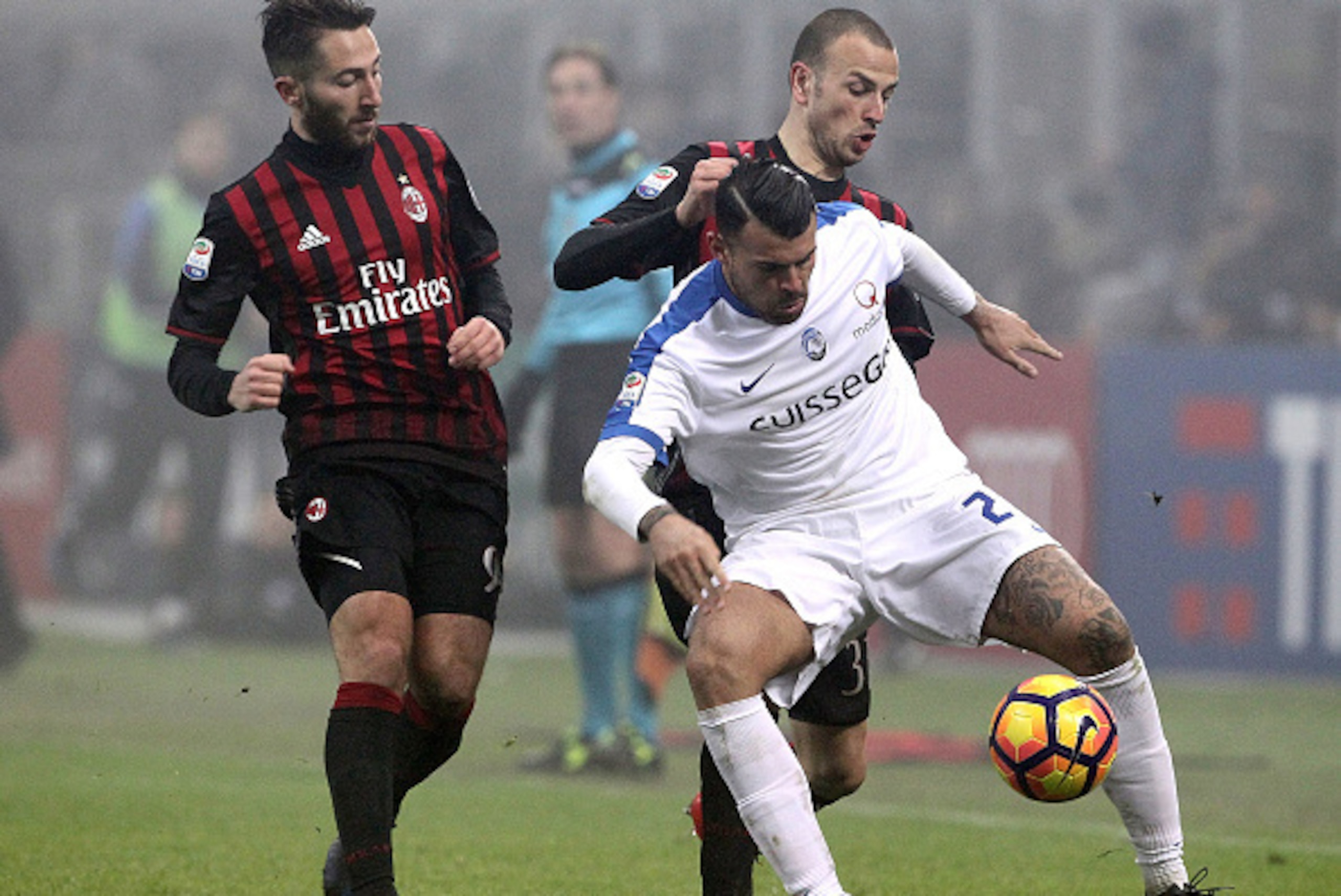 MILAN, ITALY - DECEMBER 17: Andrea Petagna of Atalanta BC is challenged by Luca Antonelli (back) and Andrea Bertolacci (L) of AC Milan during the Serie A match between AC Milan and Atalanta BC at Stadio Giuseppe Meazza on December 17, 2016 in Milan, Ital MILAN, ITALY - DECEMBER 17: Andrea Petagna of Atalanta BC is challenged by Luca Antonelli (back) and Andrea Bertolacci (L) of AC Milan during the Serie A match between AC Milan and Atalanta BC at Stadio Giuseppe Meazza on December 17, 2016 in Milan, Ital