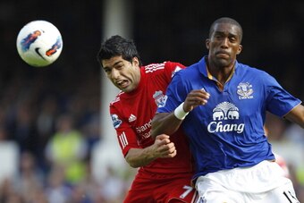 Liverpool's Uruguayan striker Luis Suarez (L) vies with Everton's French defender Sylvain Distin (R) during the English Premier League football match between Everton and Liverpool at Goodison Park in Liverpool, north-west England on October 1, 2011. AFP P