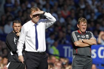 Everton's Scottish manager David Moyes (L) reacts next to Liverpool's Scottish manager Kenny Dalglish (R) during the English Premier League football match between Everton and Liverpool at Goodison Park in Liverpool, north west England, on October 1, 2011.