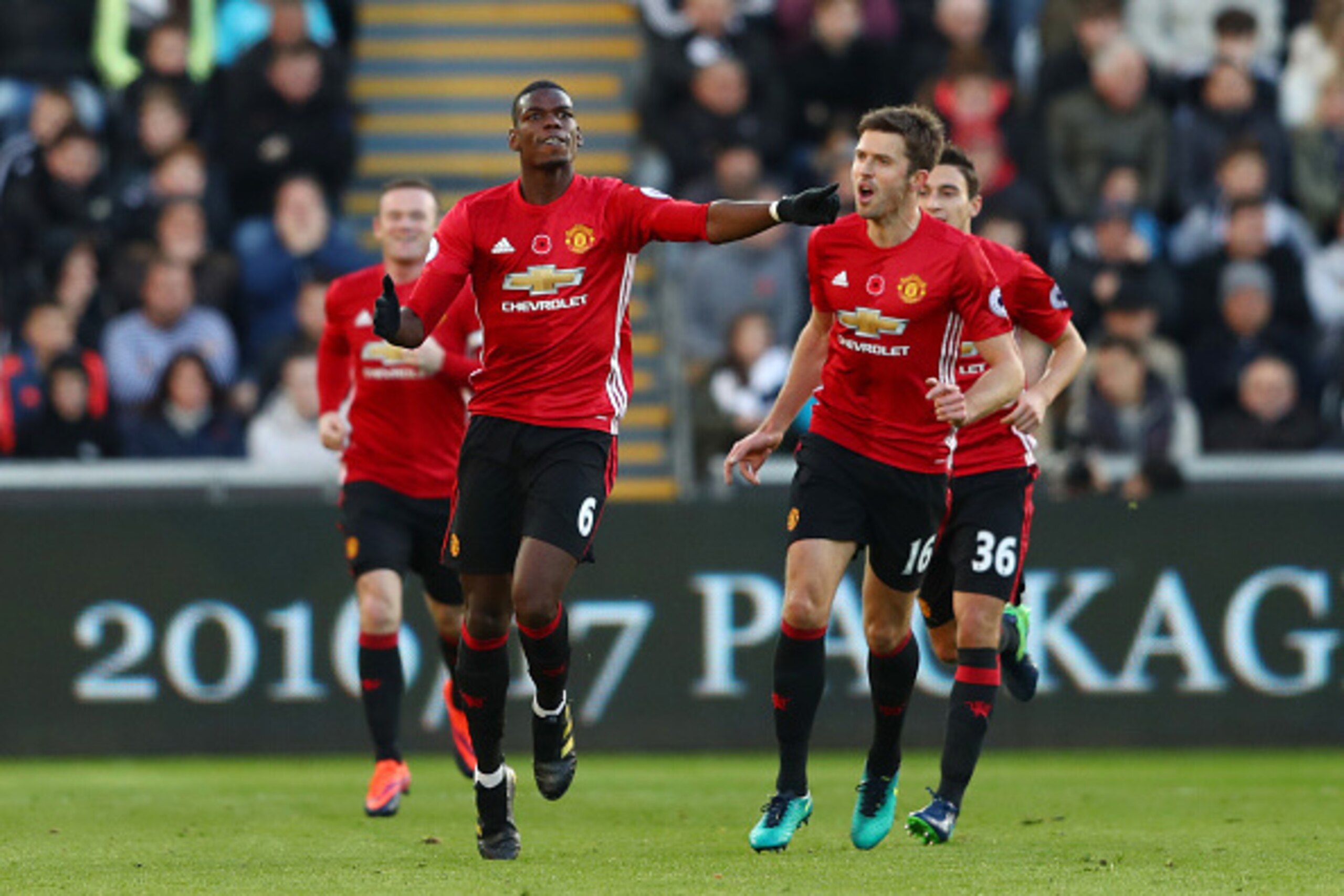 SWANSEA, WALES - NOVEMBER 06: Paul Pogba of Manchester United celebrates scoring his sides first goal with Michael Carrick during the Premier League match between Swansea City and Manchester United at Liberty Stadium on November 6, 2016 in Swansea, Wales.