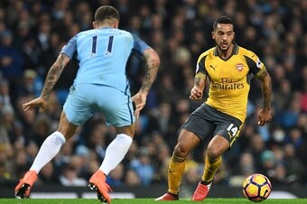 Arsenal's English midfielder Theo Walcott (R) vies with Manchester City's Serbian defender Aleksandar Kolarov during the English Premier League football match between Manchester City and Arsenal at the Etihad Stadium in Manchester, north west England, on 